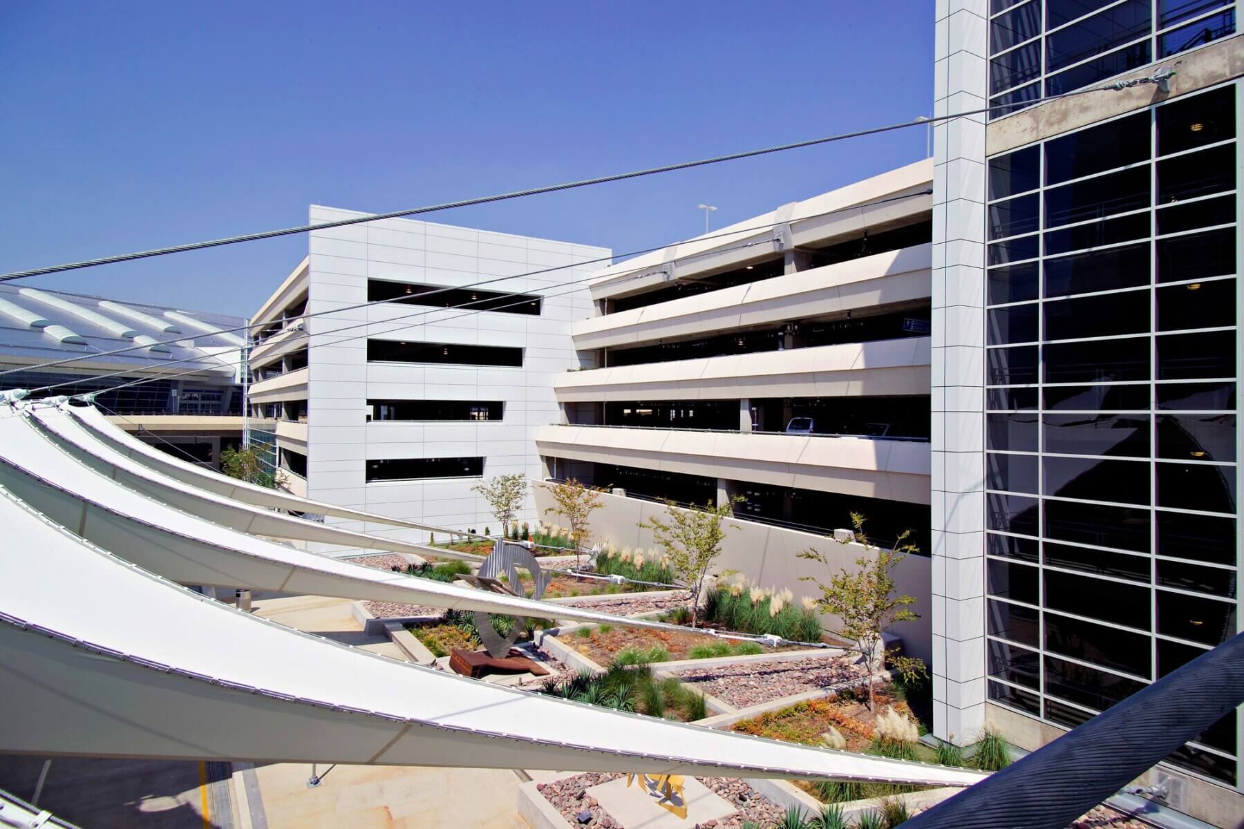 exterior planting areas and public art outside Dallas/Forth Worth International Airport parking garage D
