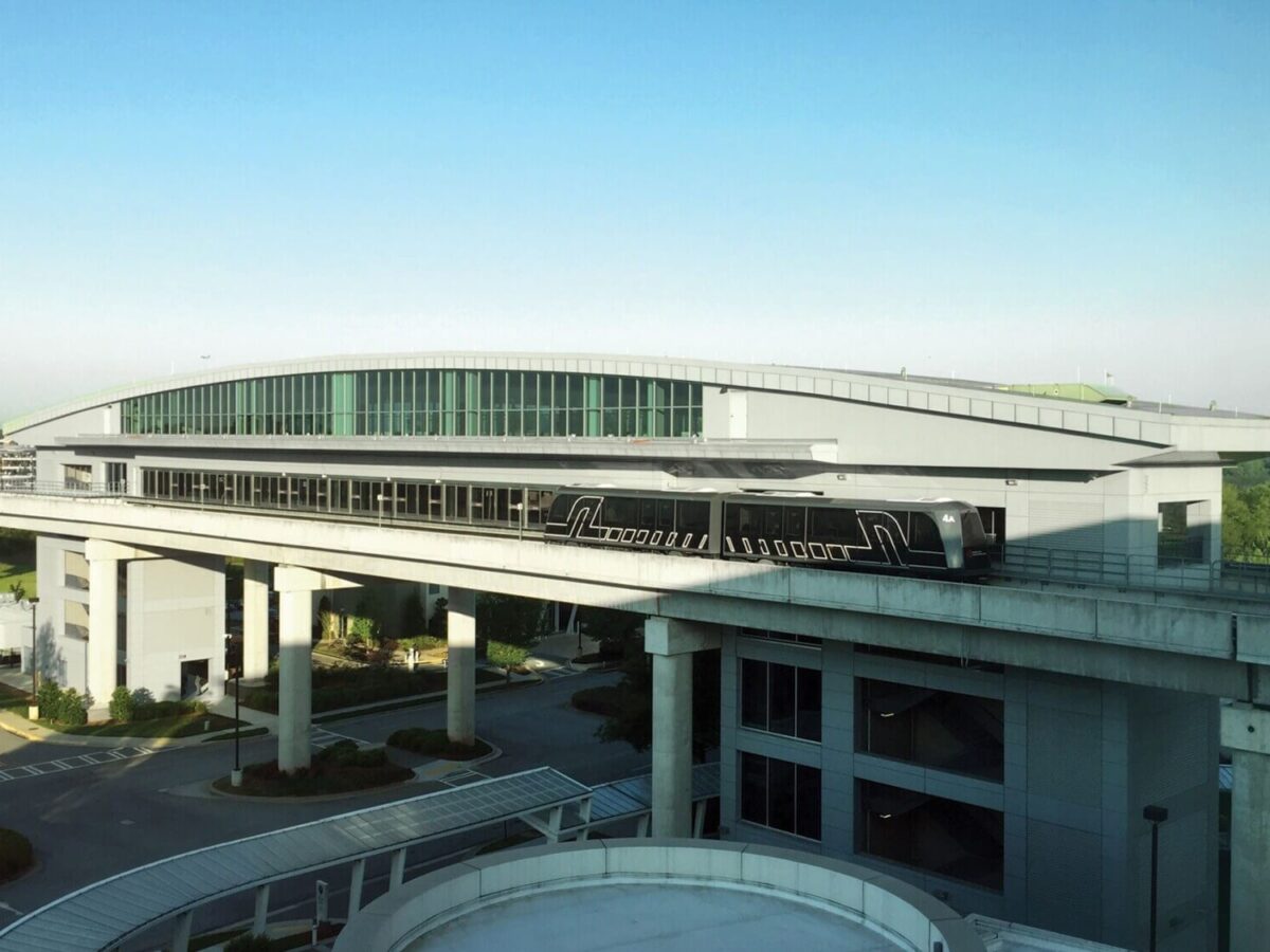 an elevated automated people mover station over a roadway at Hartsfield-Jackson Atlanta International Airport