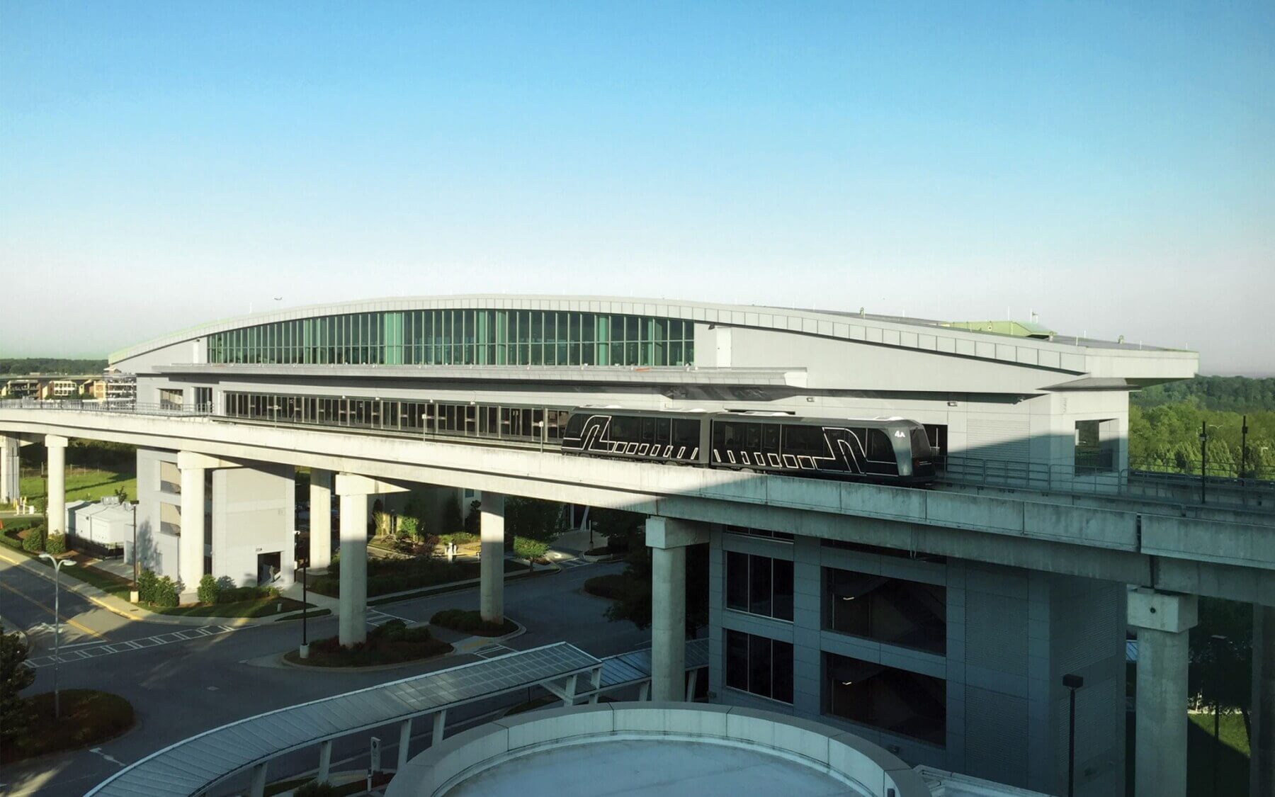 an elevated automated people mover station over a roadway at Hartsfield-Jackson Atlanta International Airport