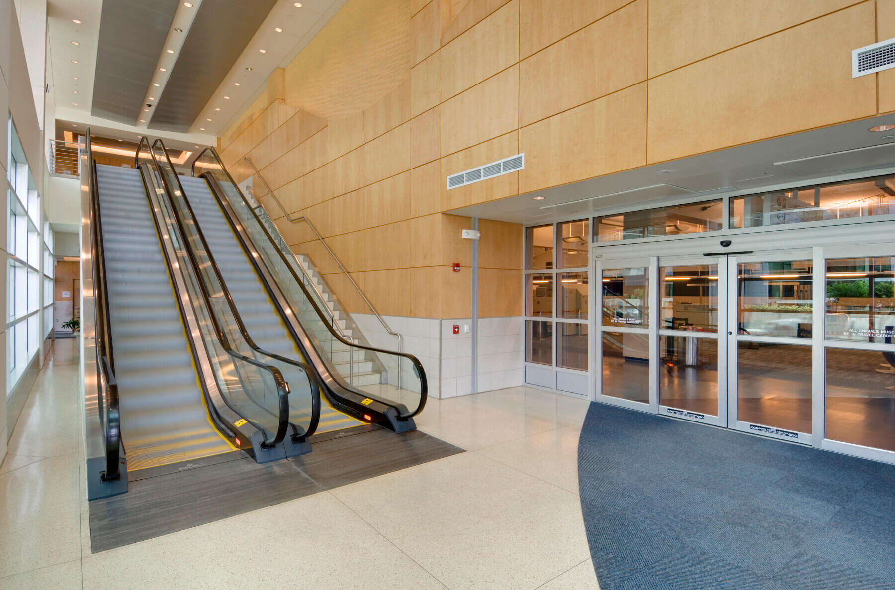 an interior lobby with escalators in Gerald R. Ford International Airport parking garage