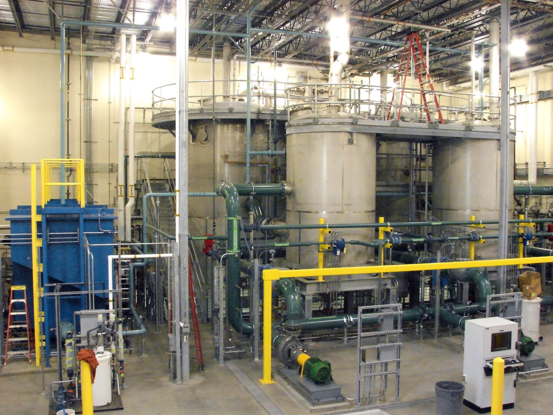 deicer management system mechanical equipment in a facility at Portland International Airport in the background