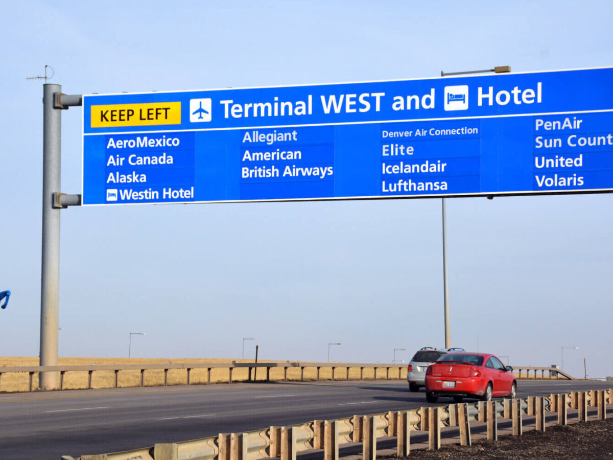 overhead directional signage on the roadway leading to Denver International Airport