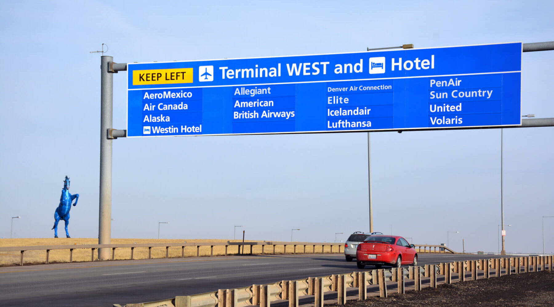 overhead directional signage on the roadway leading to Denver International Airport