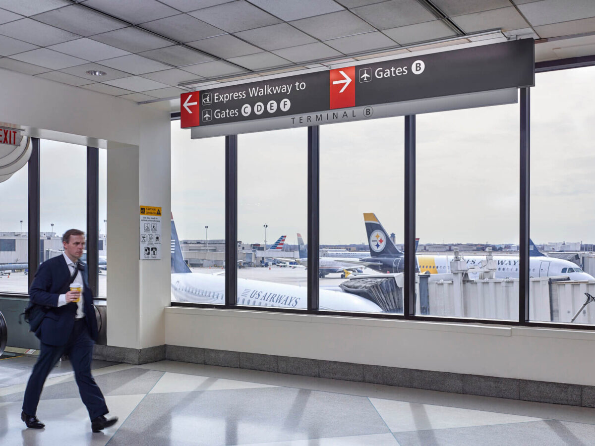 a man walking through the concourse in terminal B at Philadelphia International Airport