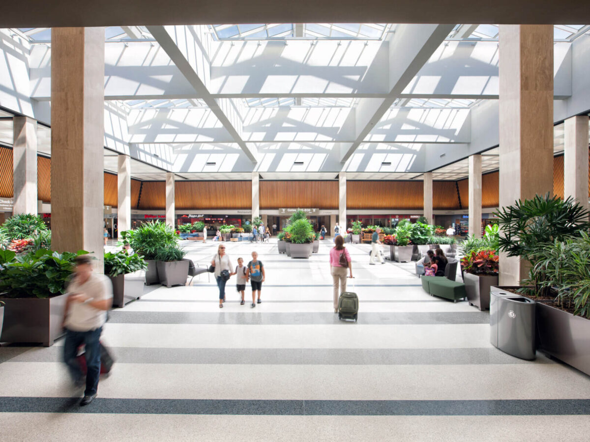passengers waking through the terminal under a large skylight at Norfolk International Airport