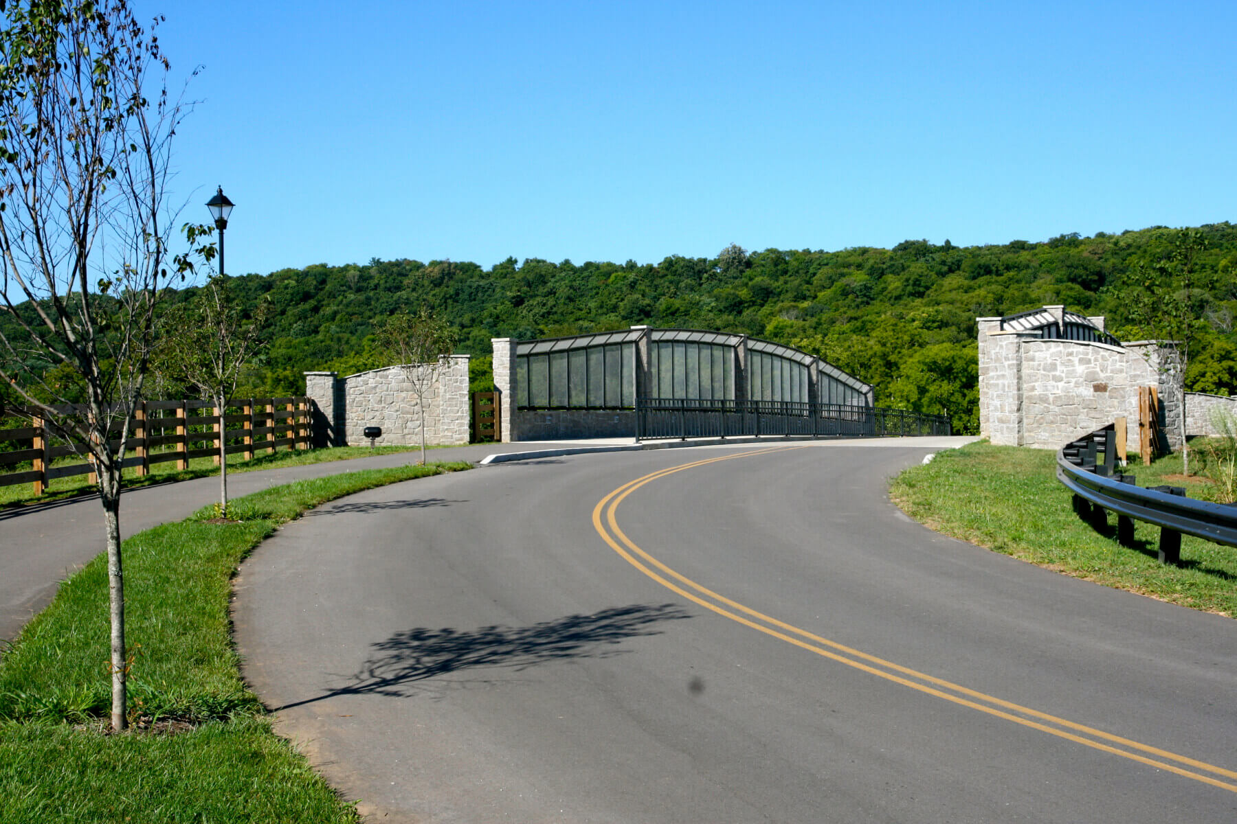 A road going over a bridge with trees in the background at Marcella Vivrette Smith Park