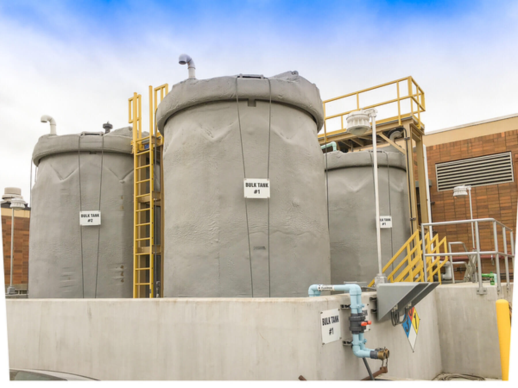 Three large bulk storage tanks.