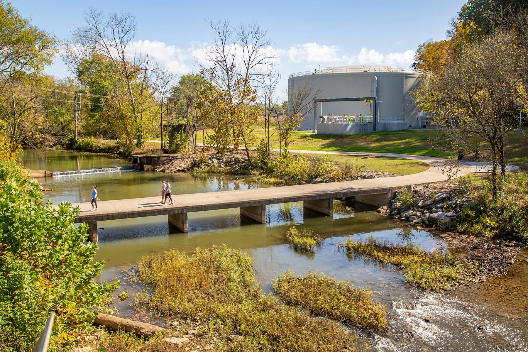 A bridge over a river with people walking across it
