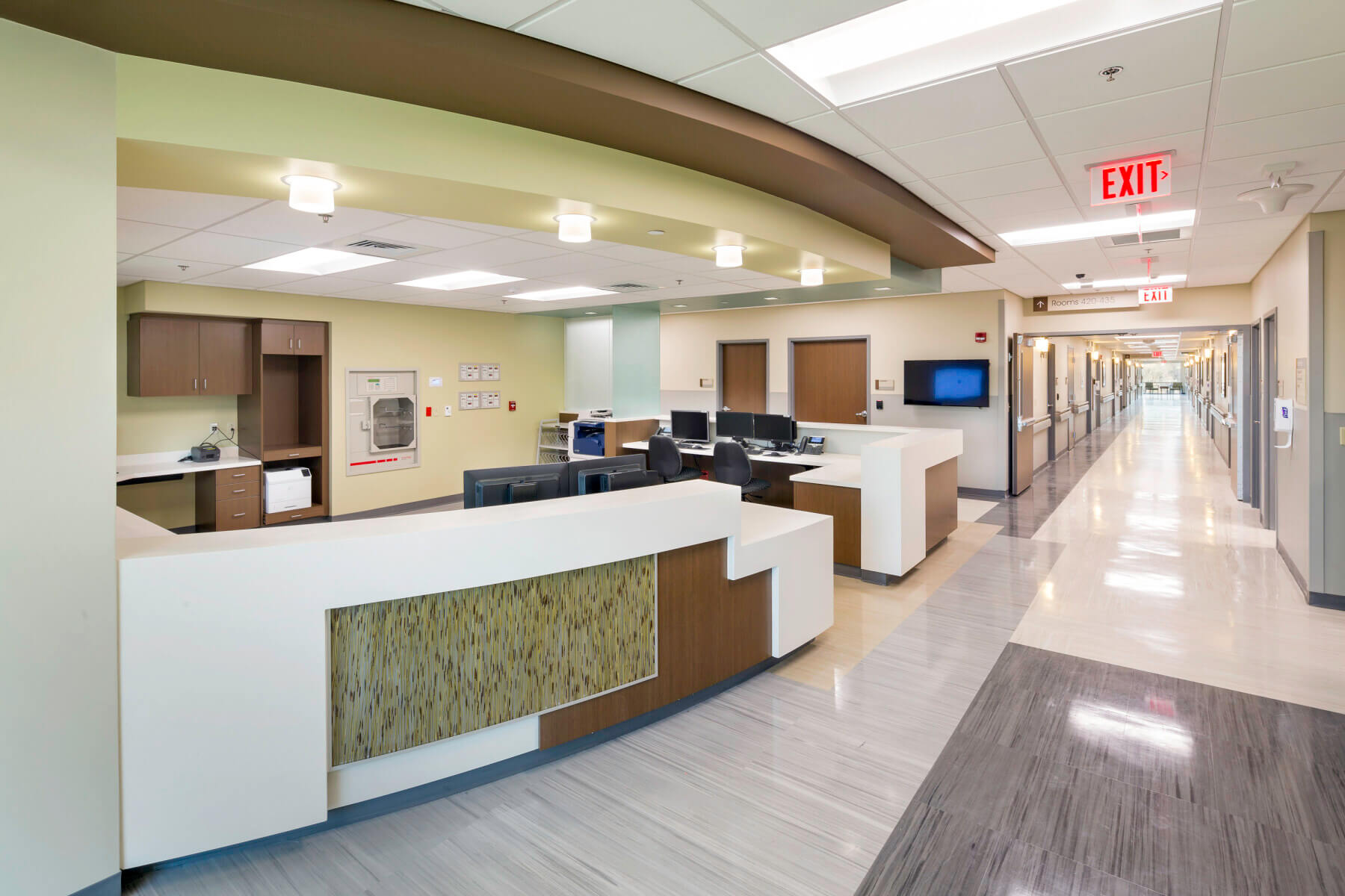 unoccupied check in desk with long hallway in the background