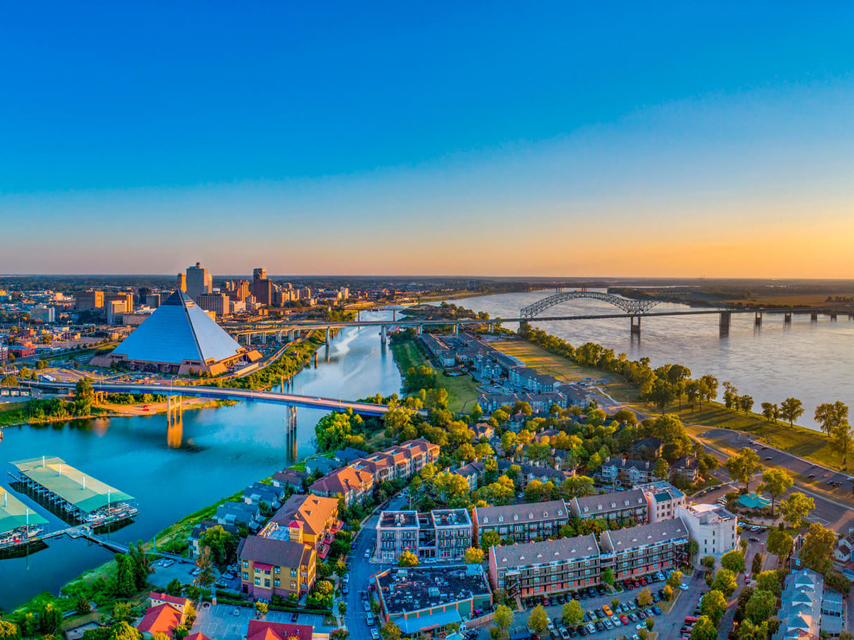 An aerial view of downtown Memphis showing the Memphis Pyramid and the Mississippi River.