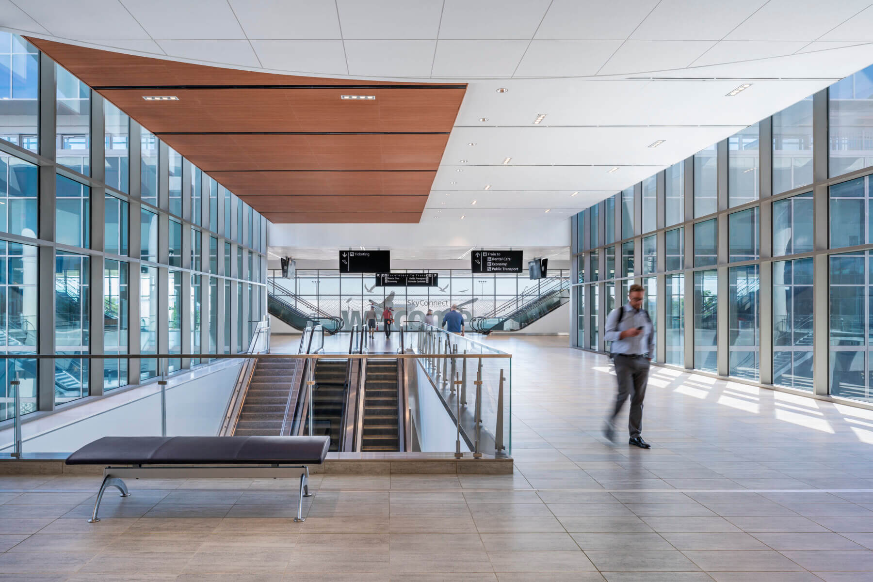 people walking through a lobby towards the automated people mover at Tampa International Airport