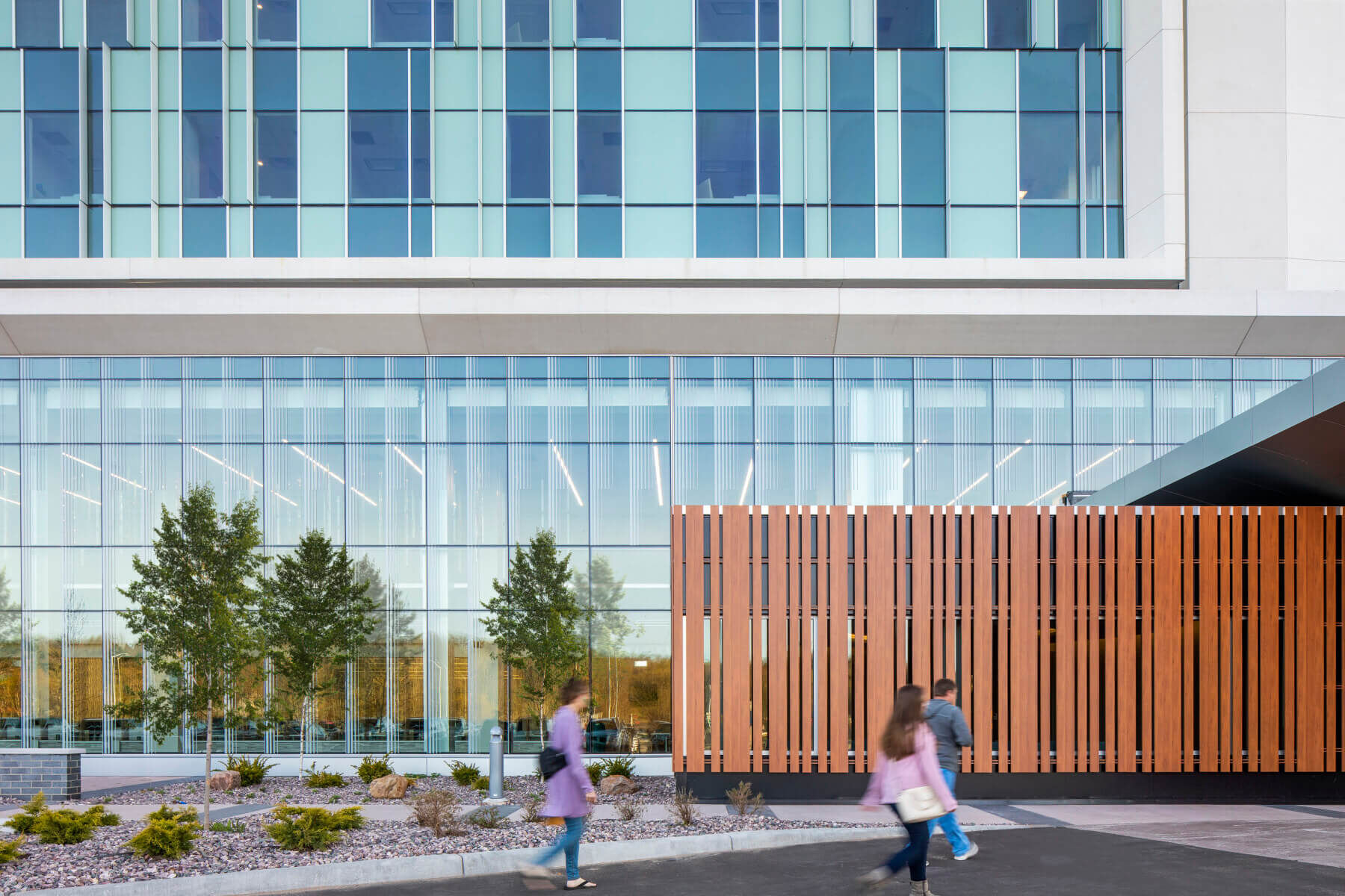 visitors walking from parking lot to building entrance