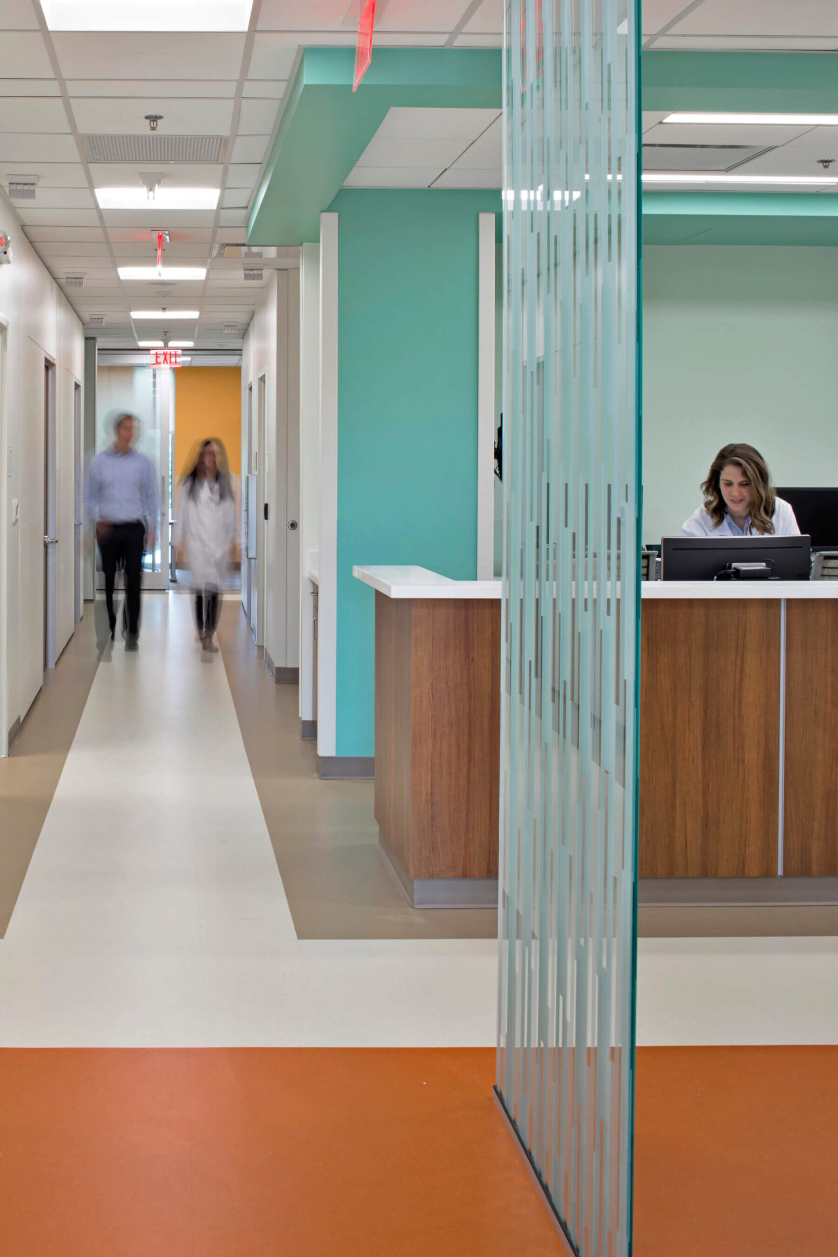 people walking down a corridor in the clinic