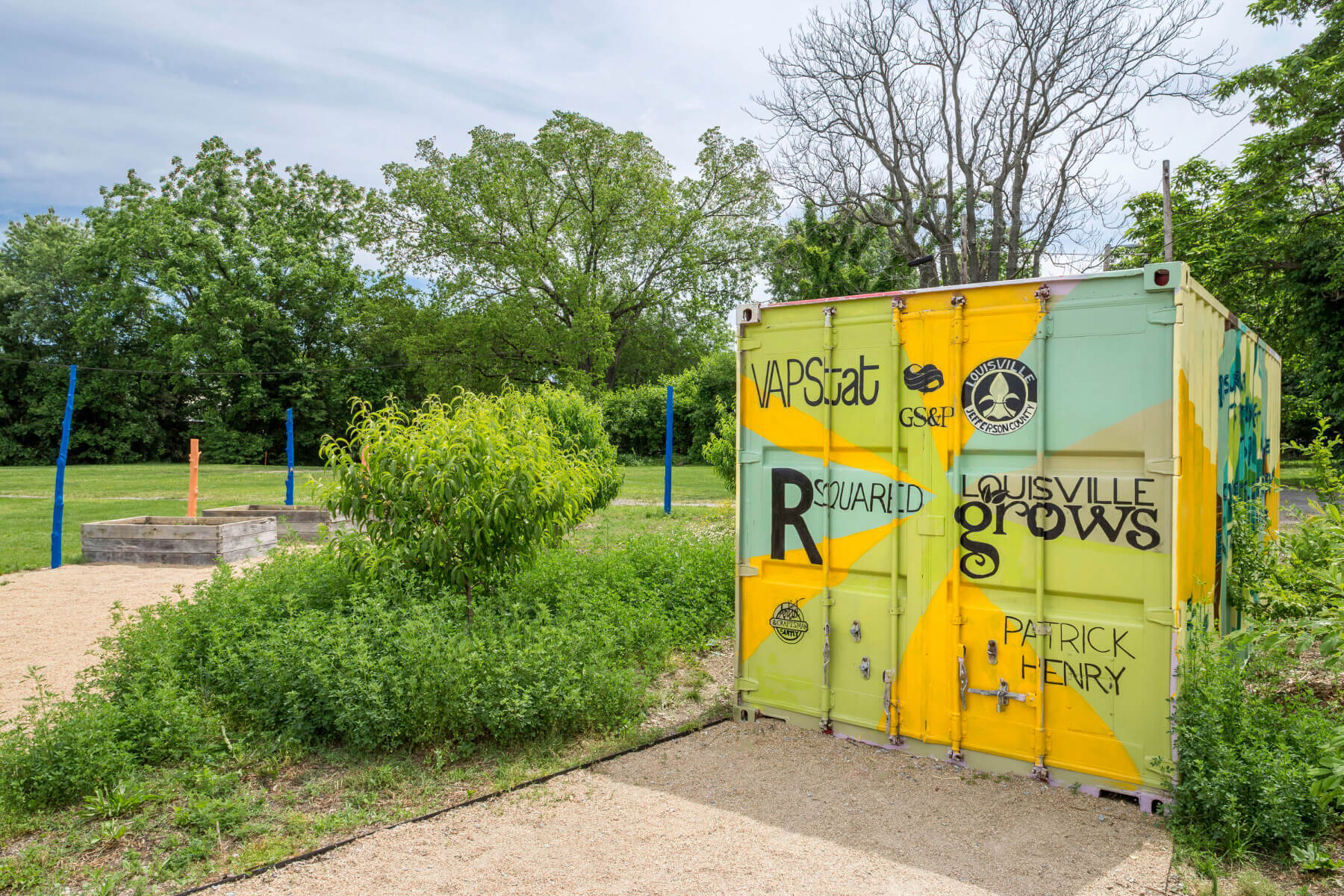 a mural surrounded with trees and grass