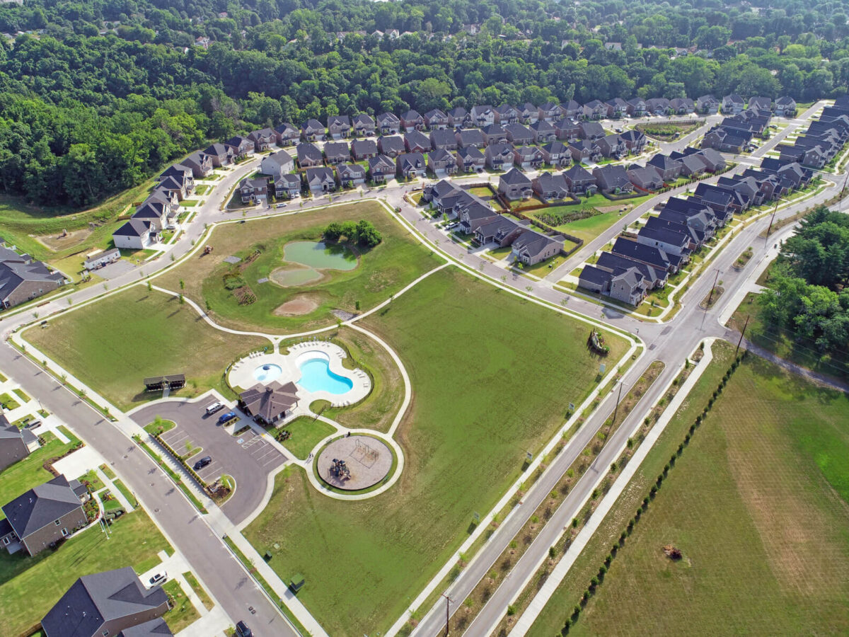 an aerial shot of houses and a pool