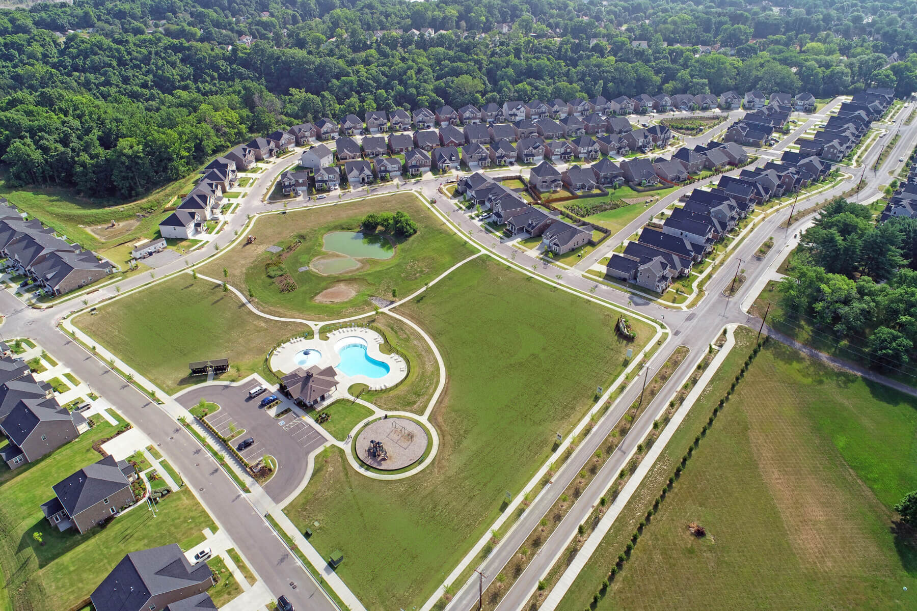 an aerial shot of houses and a pool