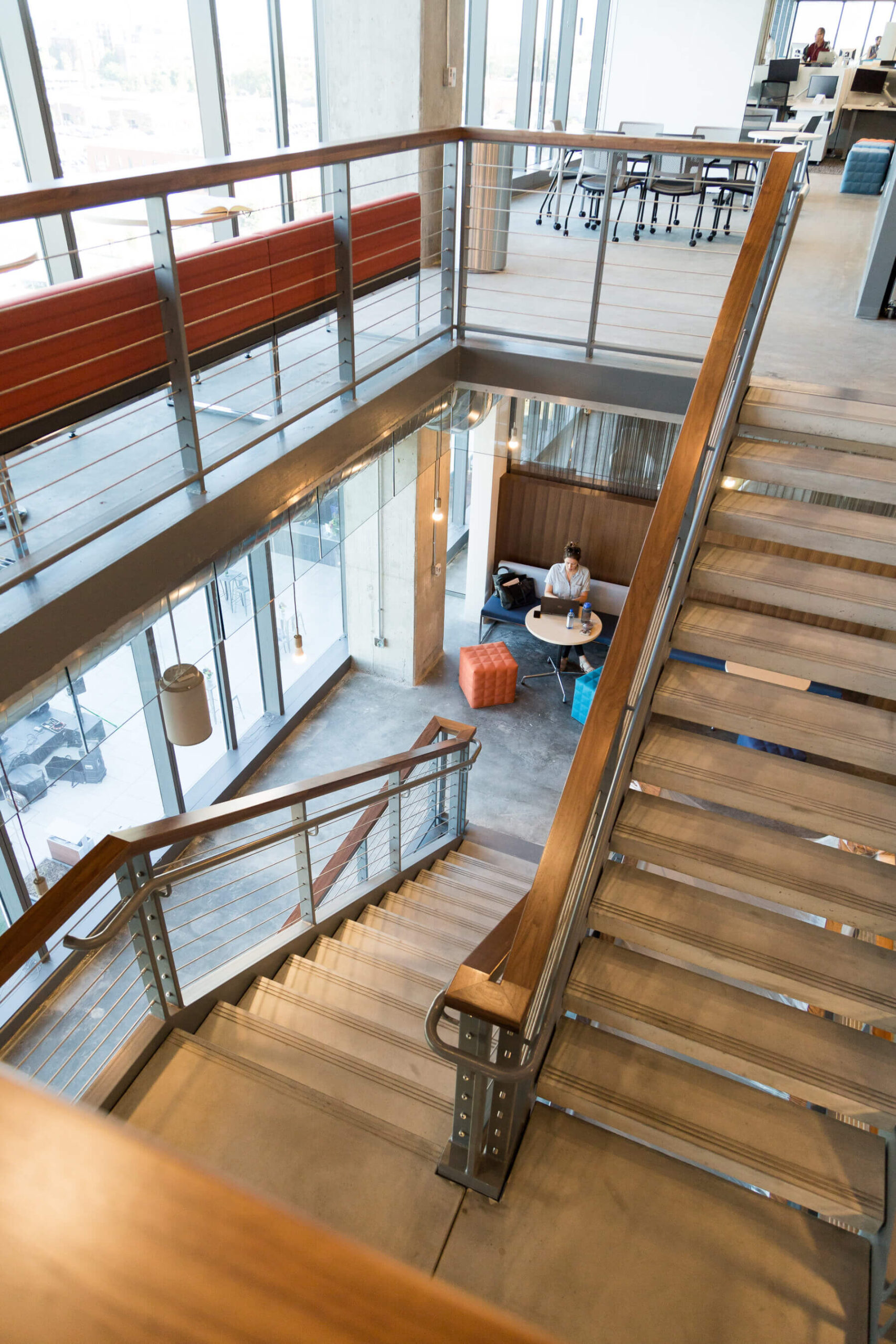downward view of staircase and employees working below