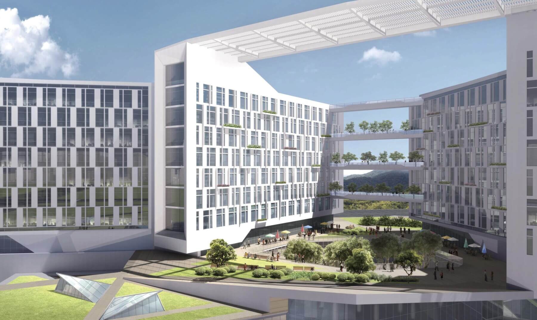 courtyard with seating areas and trees in between hospital buildings