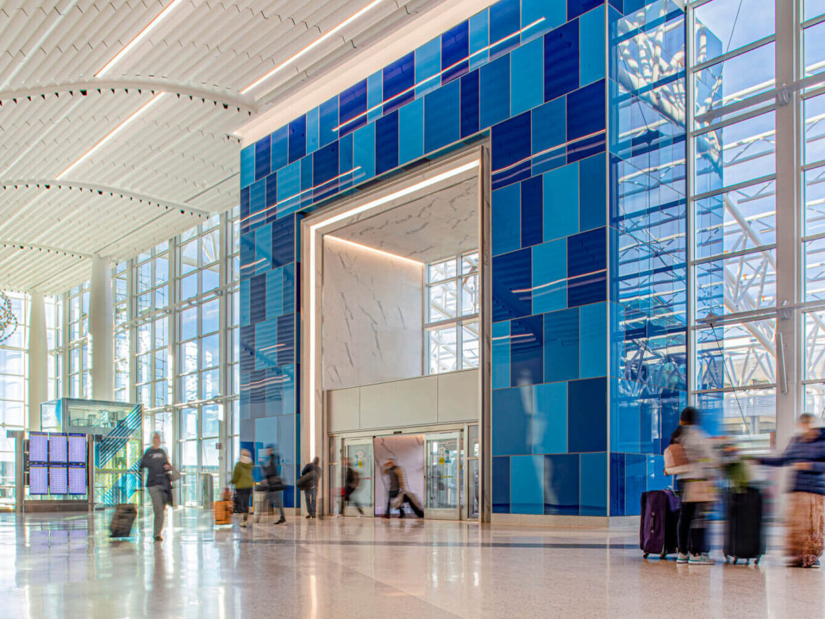 the blue glass-clad entrance to Charlotte Douglas International Airport’s terminal lobby