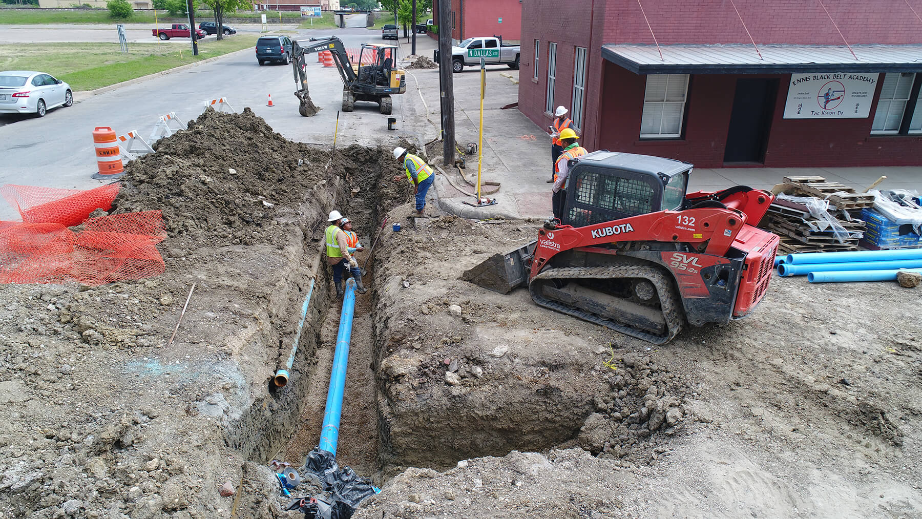 Construction workers install a water pipe in downtown Ennis