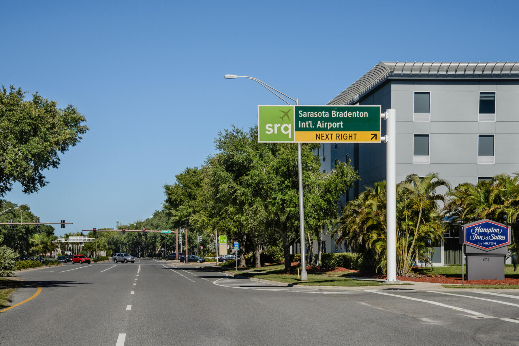 overhead roadway sign directing drivers to the entrance to Sarasota Bradenton International Airport