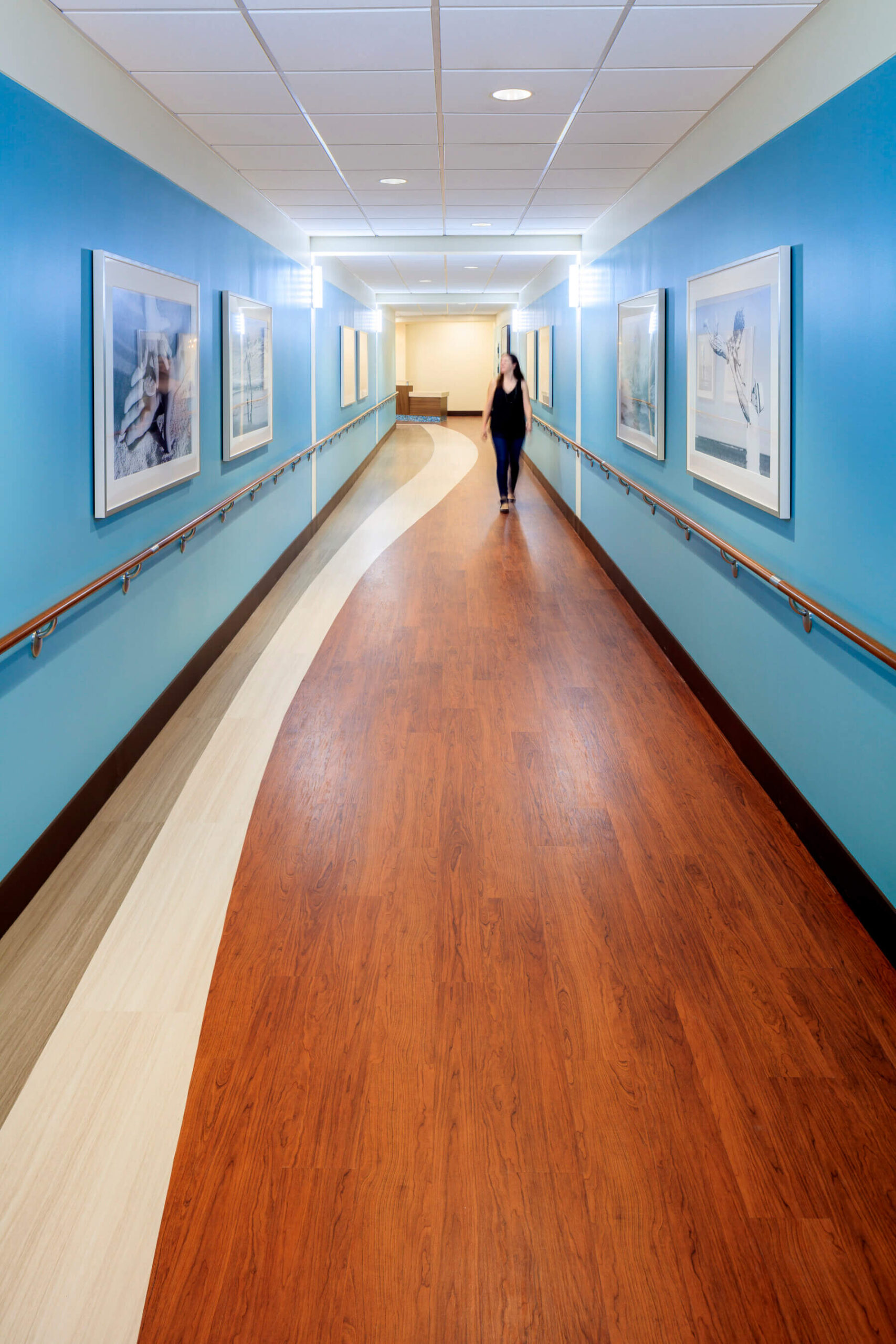 hallway painted blue with pictures hanging on the wall
