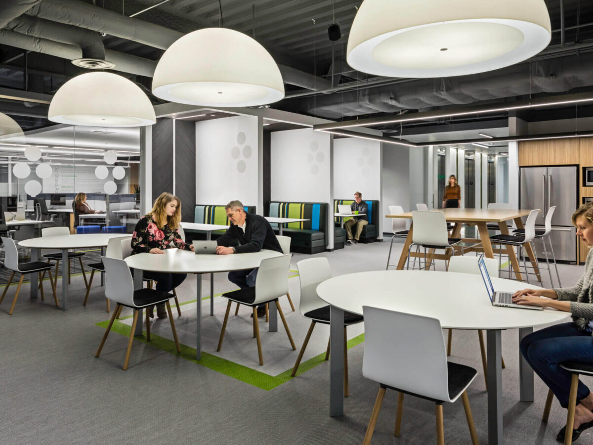 a hub with tables and a kitchen in the Schneider Electric Offices