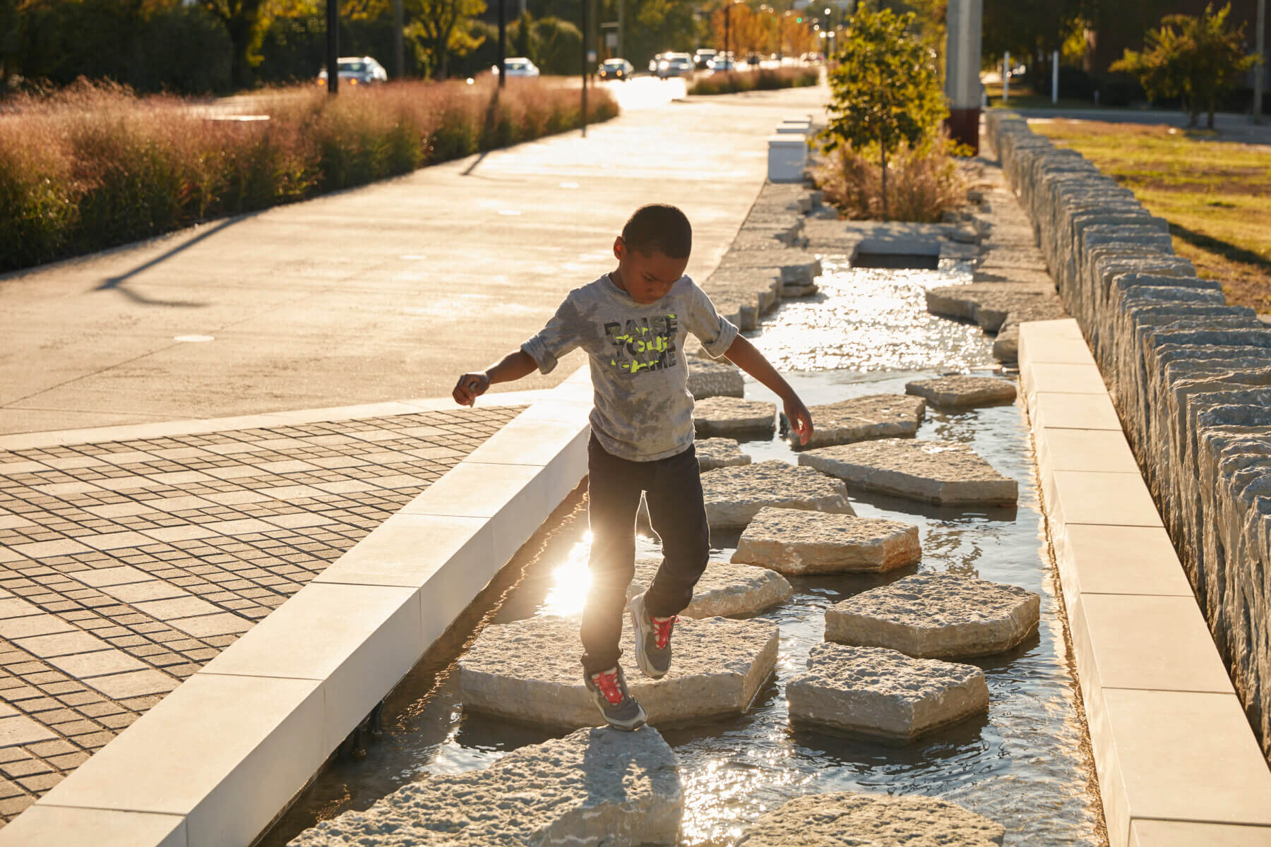 A child playing in the water at Town Branch Commons