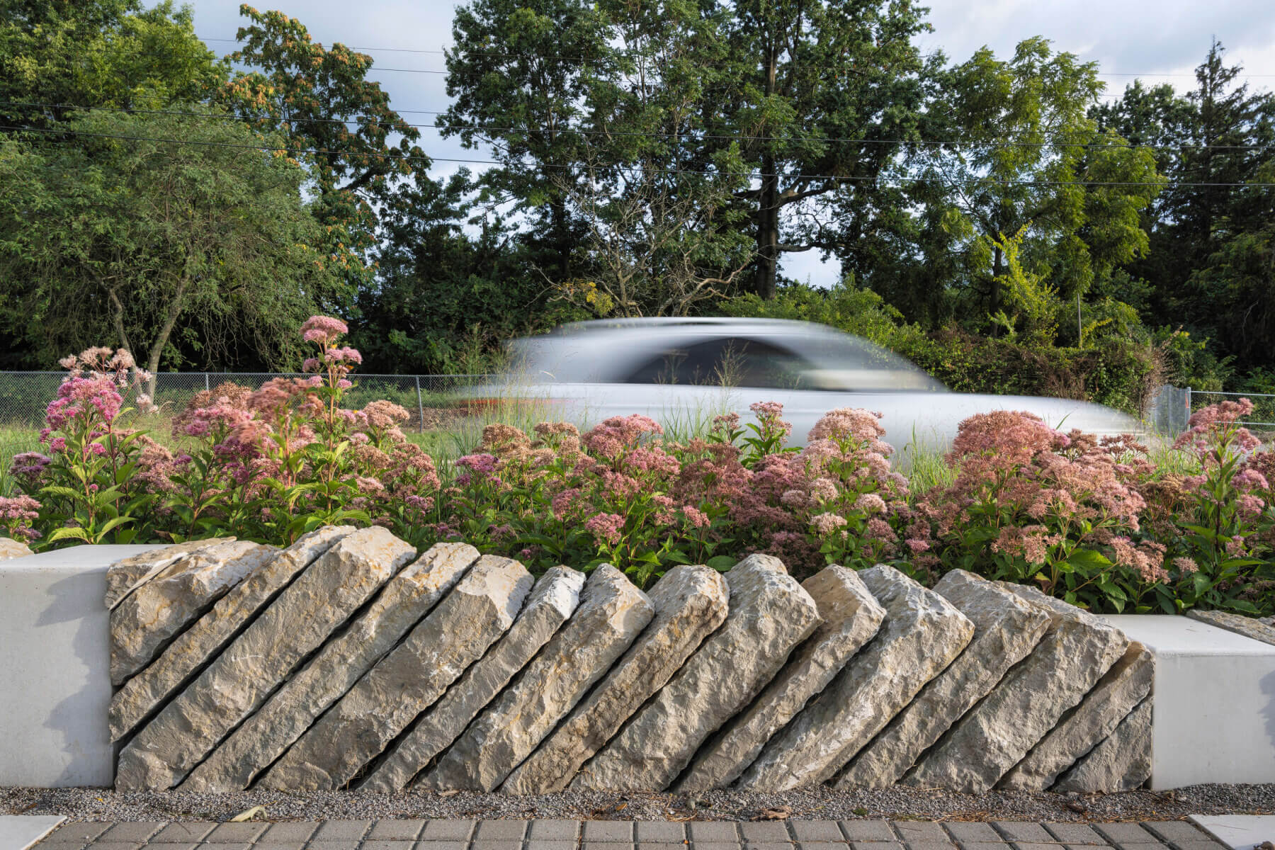 stacked rocks with flowers behind at Town Branch Commons