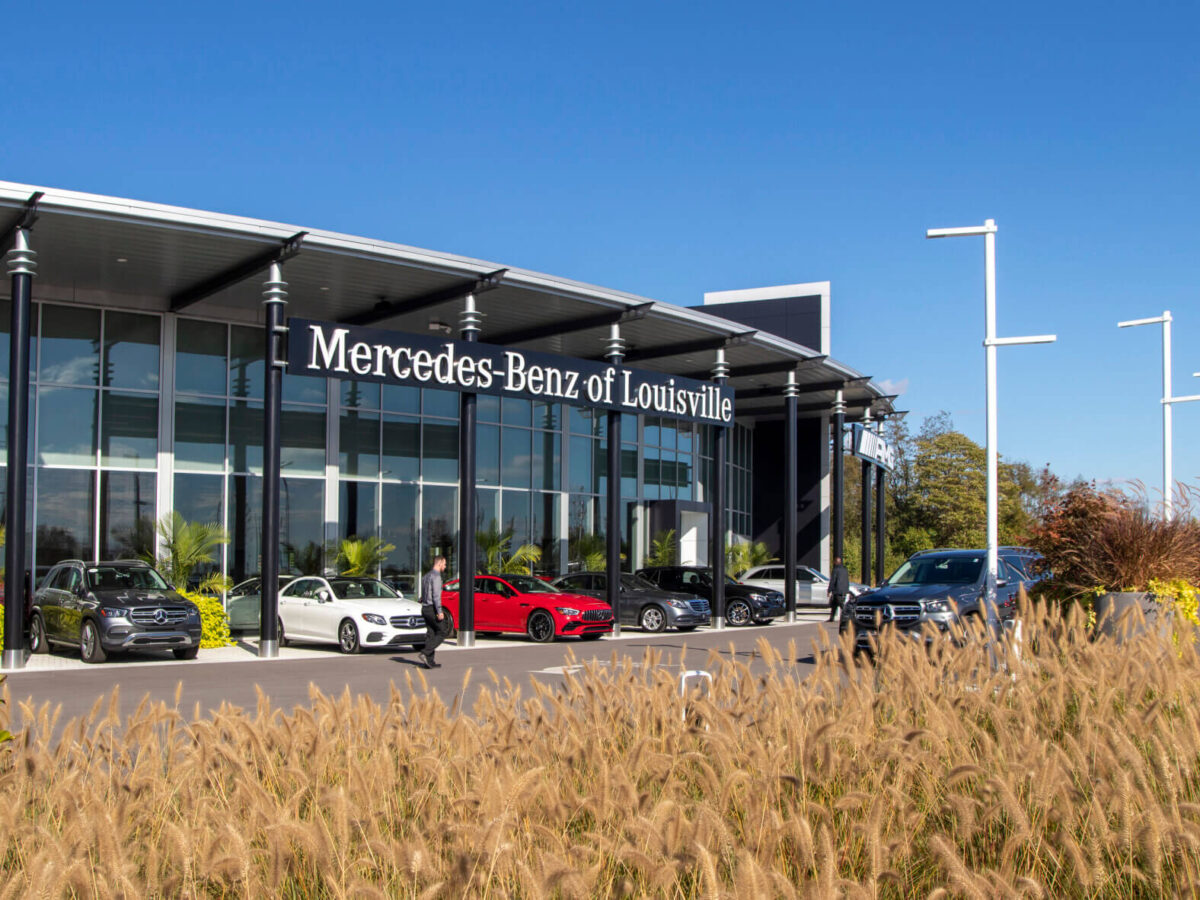 the Mercedes-Benz of Louisville exterior of the building lined with cars