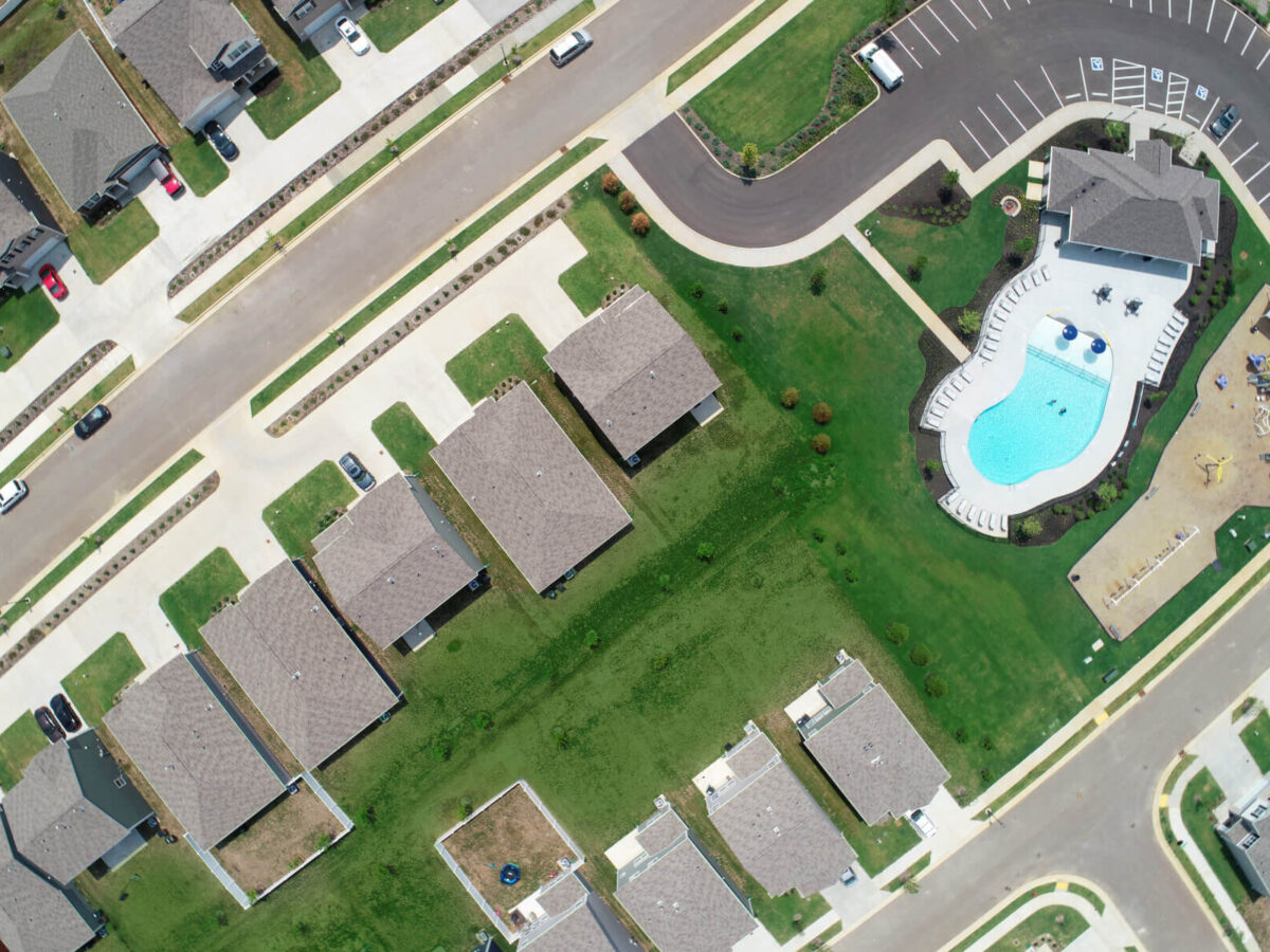 a drone shot of Heritage Landing showing a pool and houses