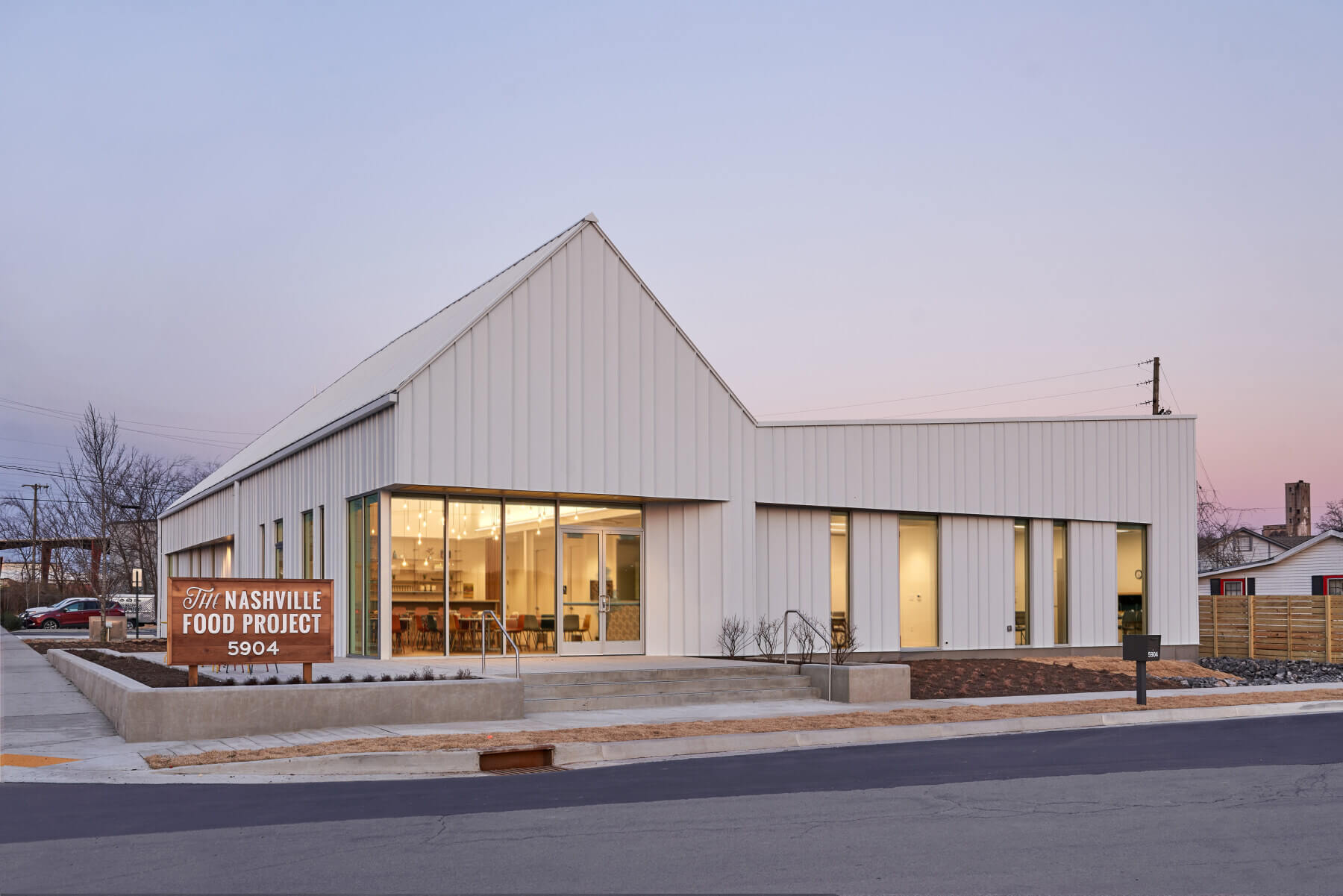 The exterior of the Nashville Food Project with a man walking in front of it