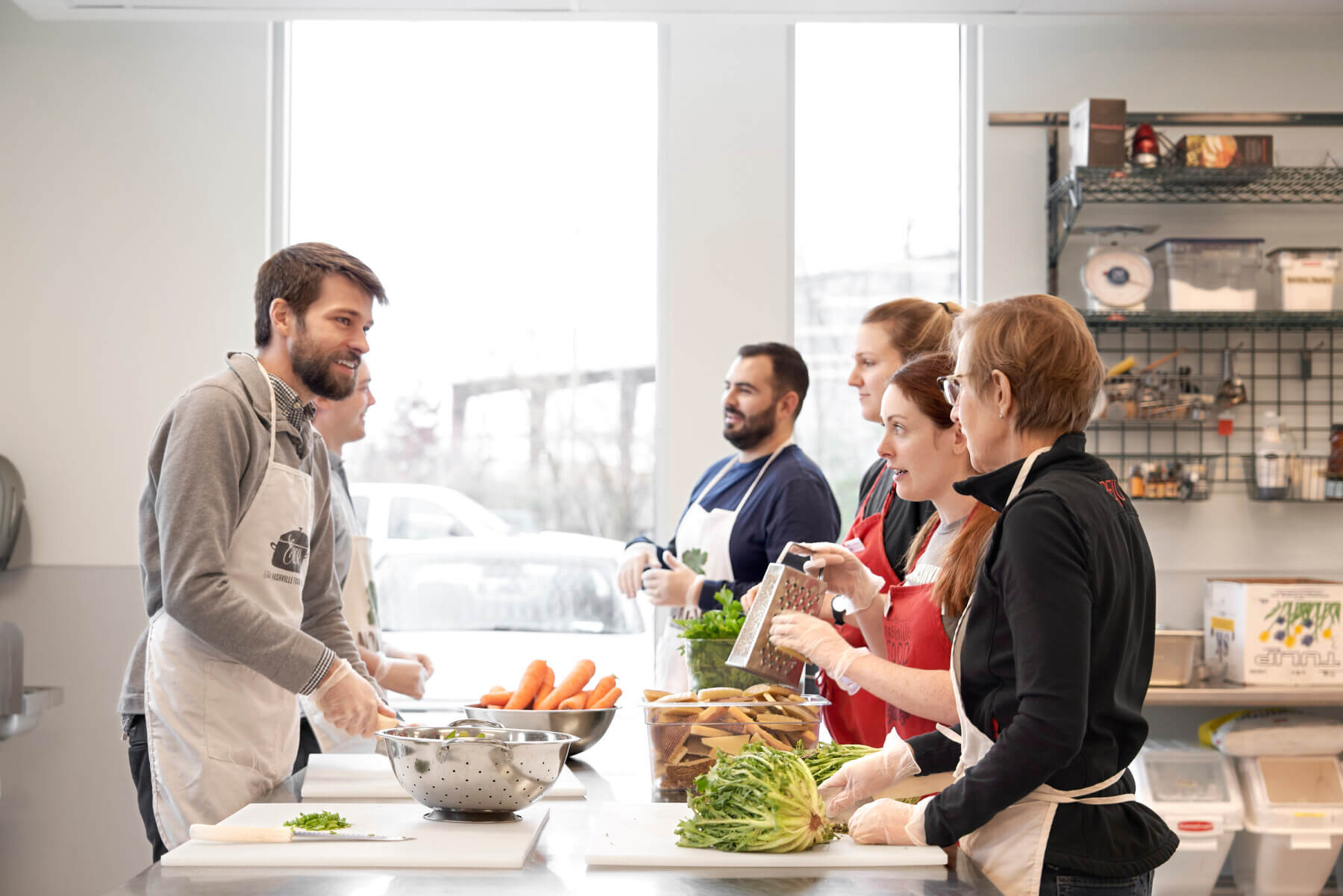 The interior of the Nashville Food Project people prepping vegetables at a table