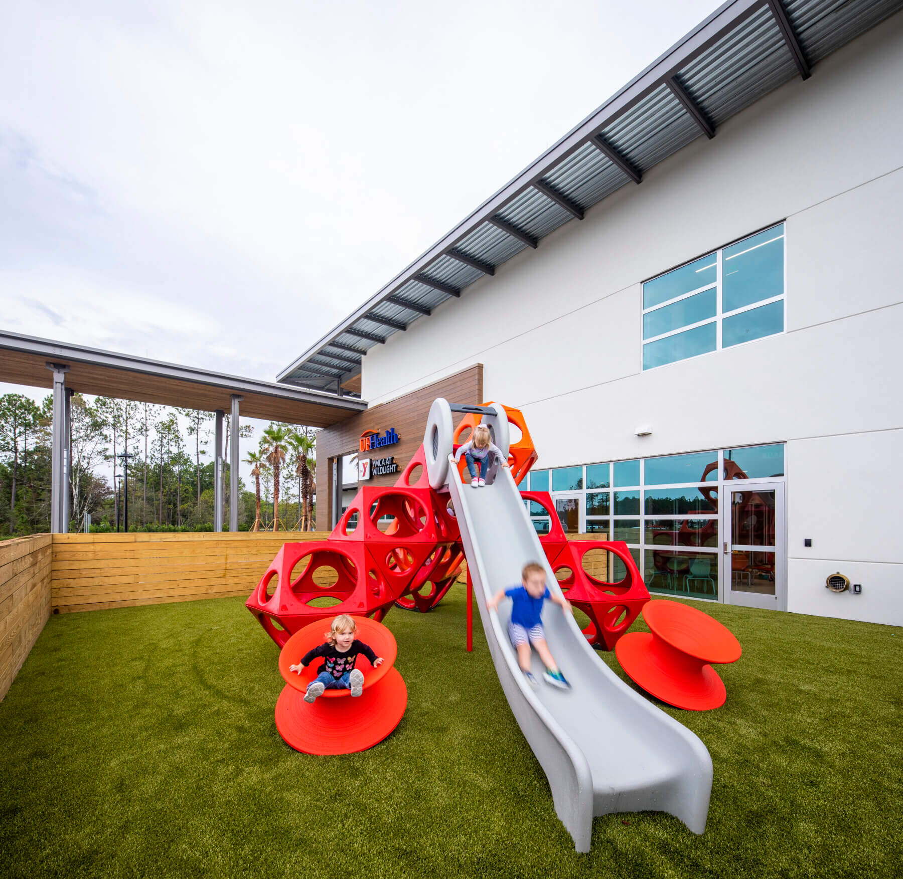 children playing and sliding on playground in outside courtyard