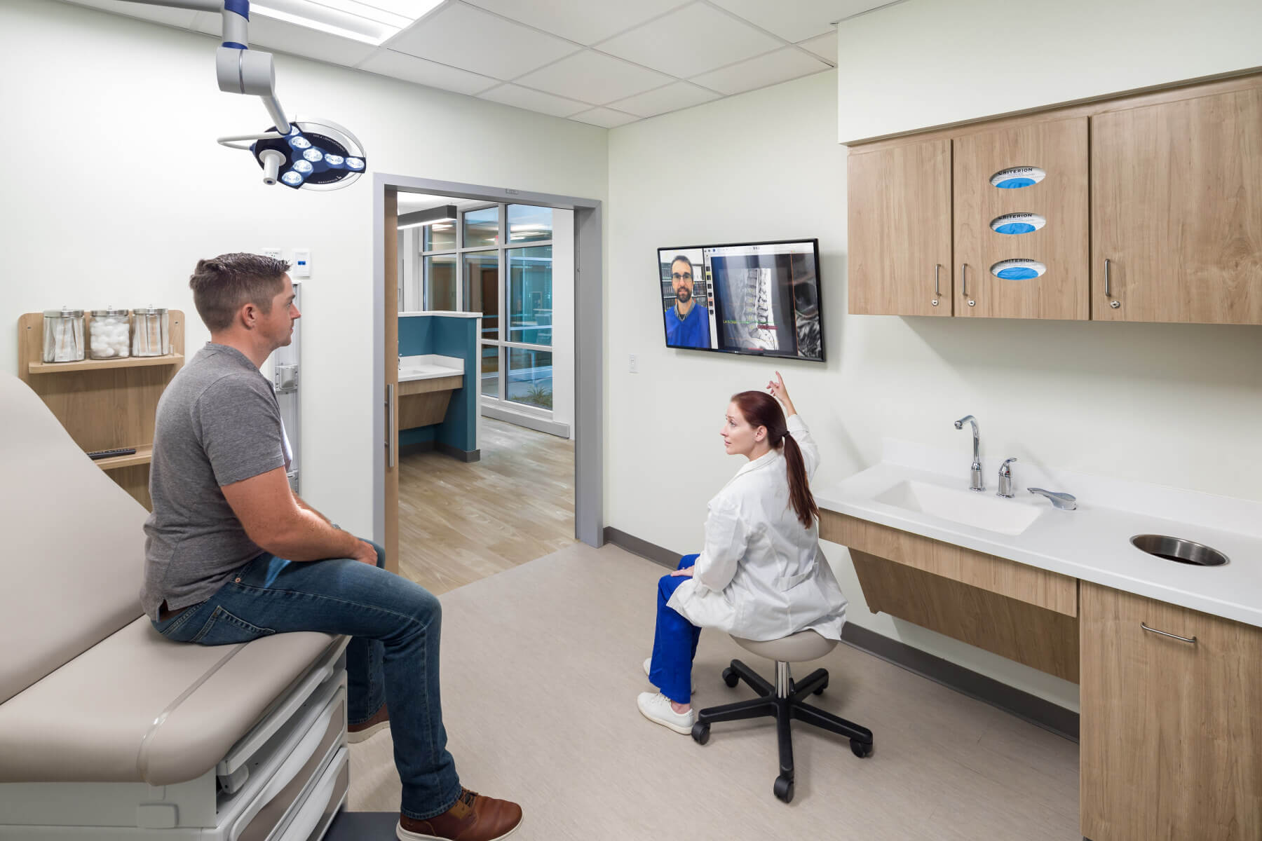 doctor showing spine x-ray to male patient