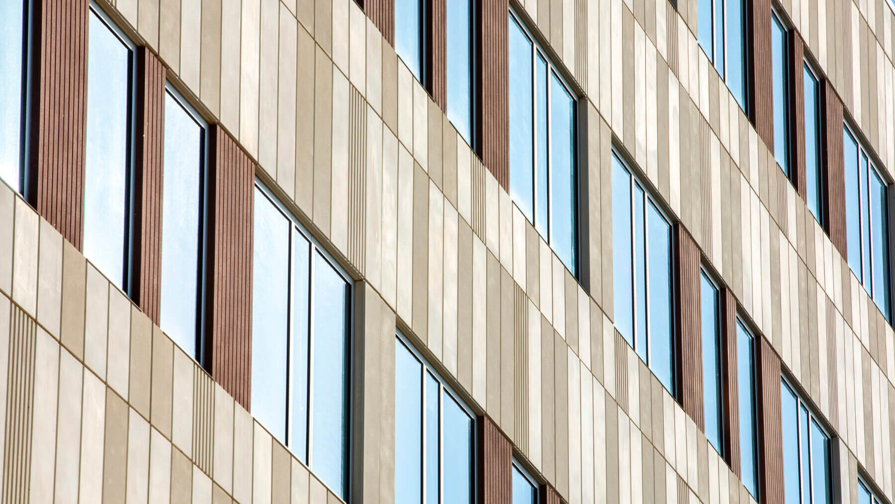 the concrete and glass façade of a building
