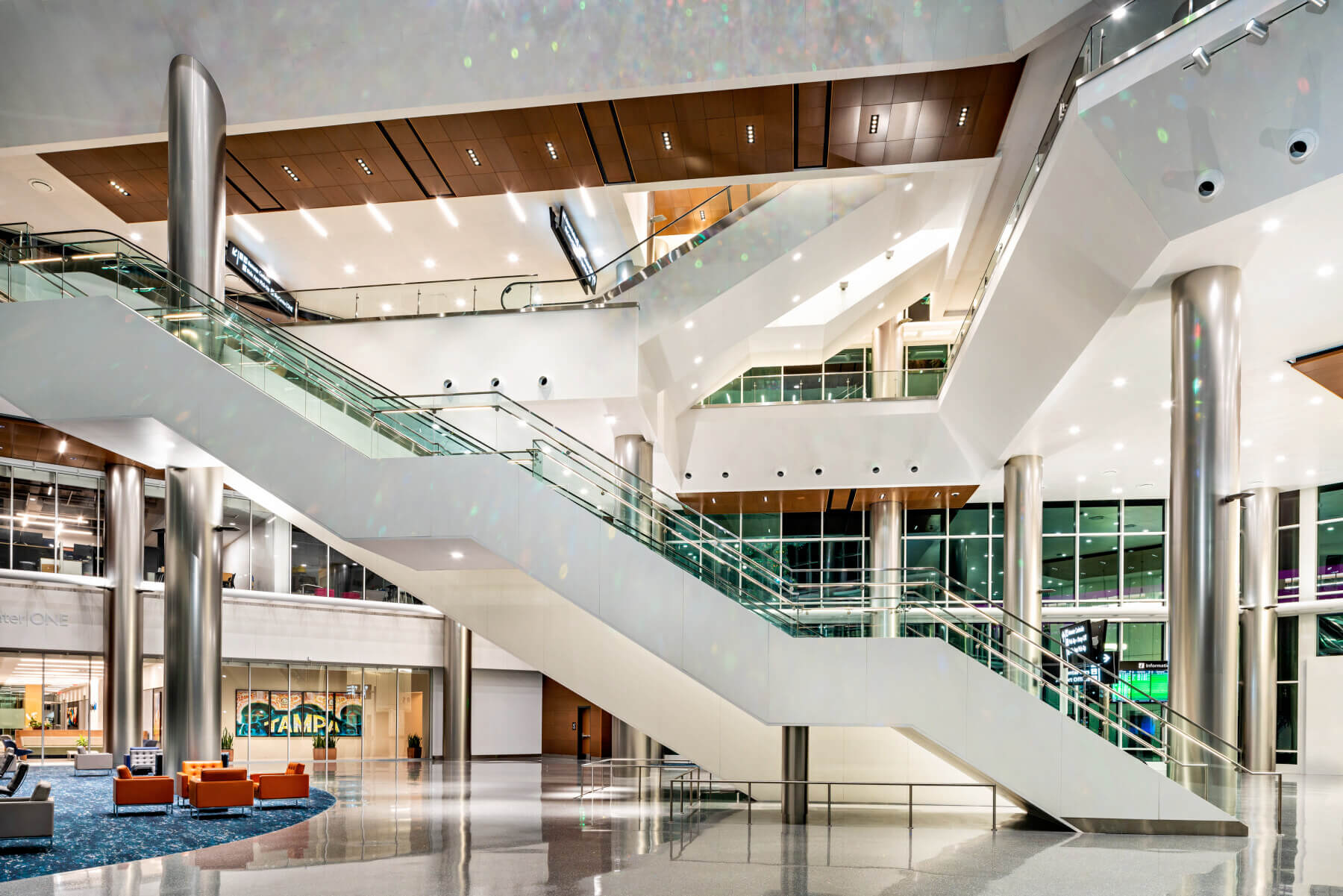 monumental staircase and art sculpture hanging from the ceiling in the atrium at the SkyCenter development at Tampa International Airport