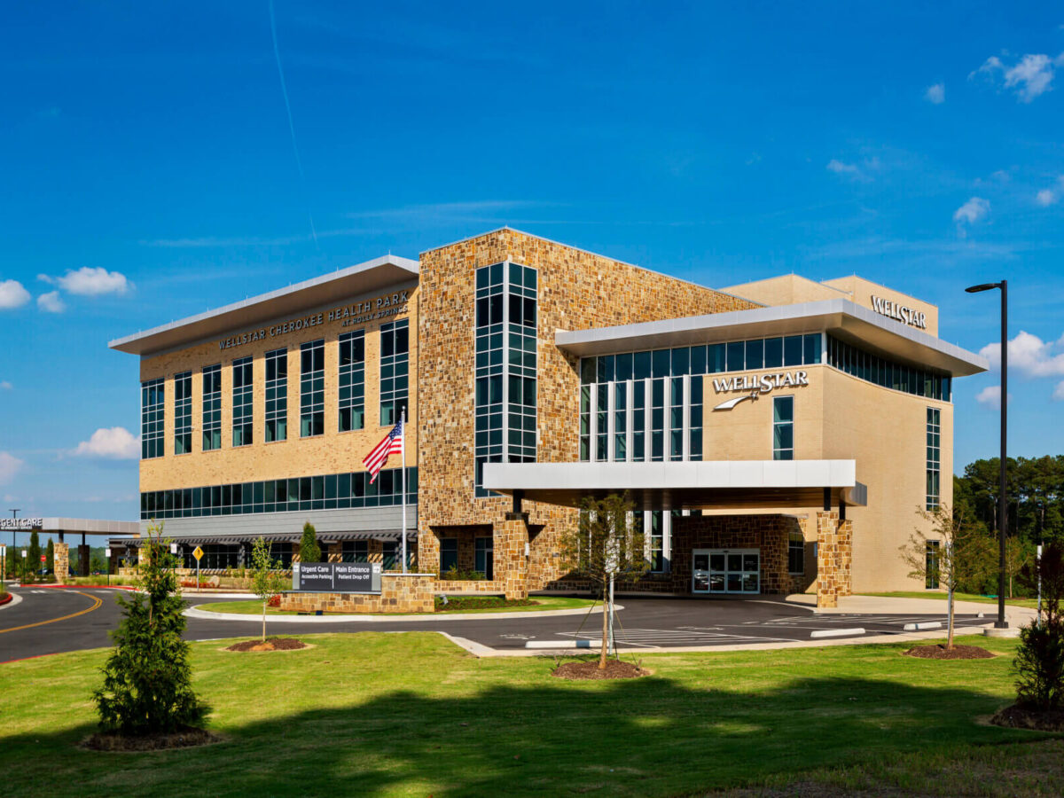 exterior view of facility with blue skies and American flag at the entrance