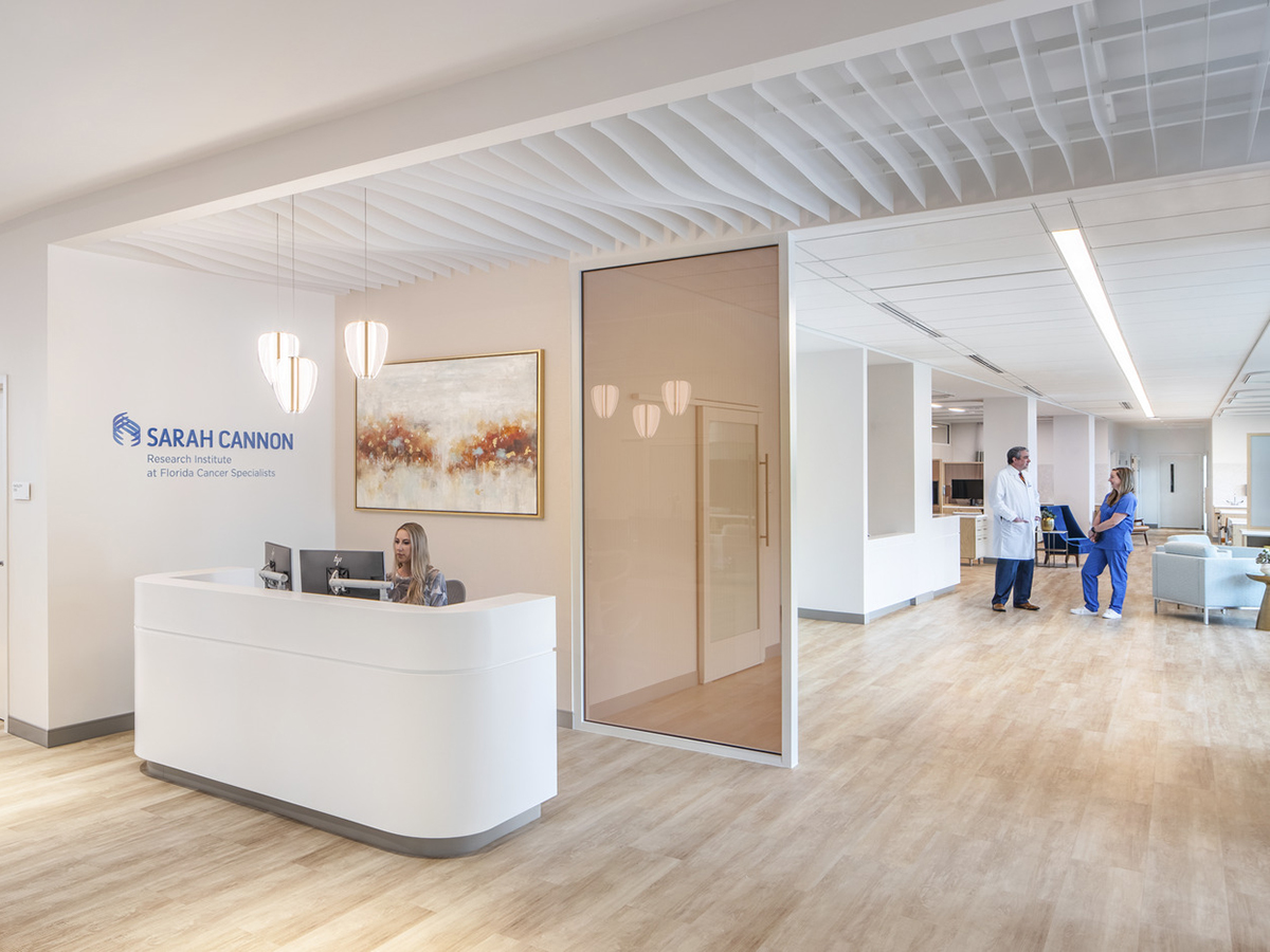 a person sitting at the reception desk at a Sarah Cannon cancer center