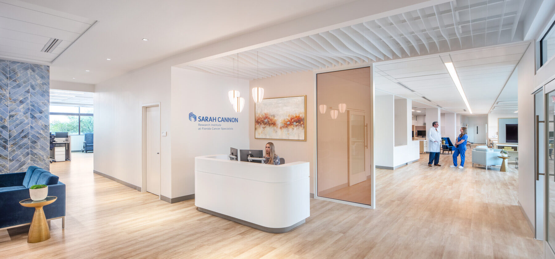 person sitting behind reception desk