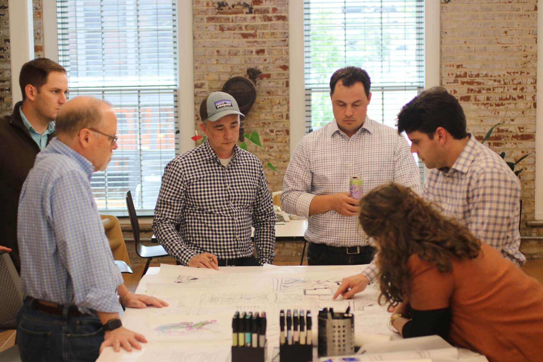 people gathered around landscape architecture plans