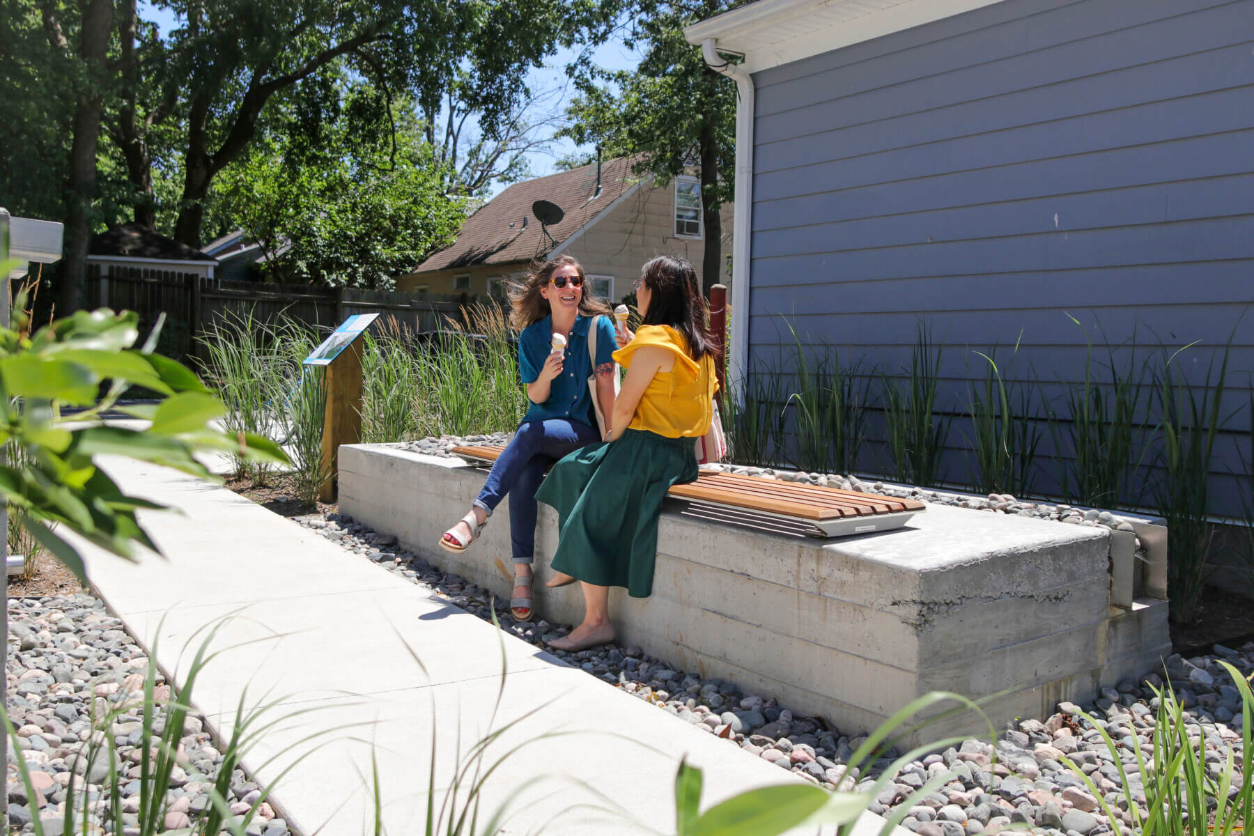 people sitting on a raised bioswale at the Gardens at 900 Block