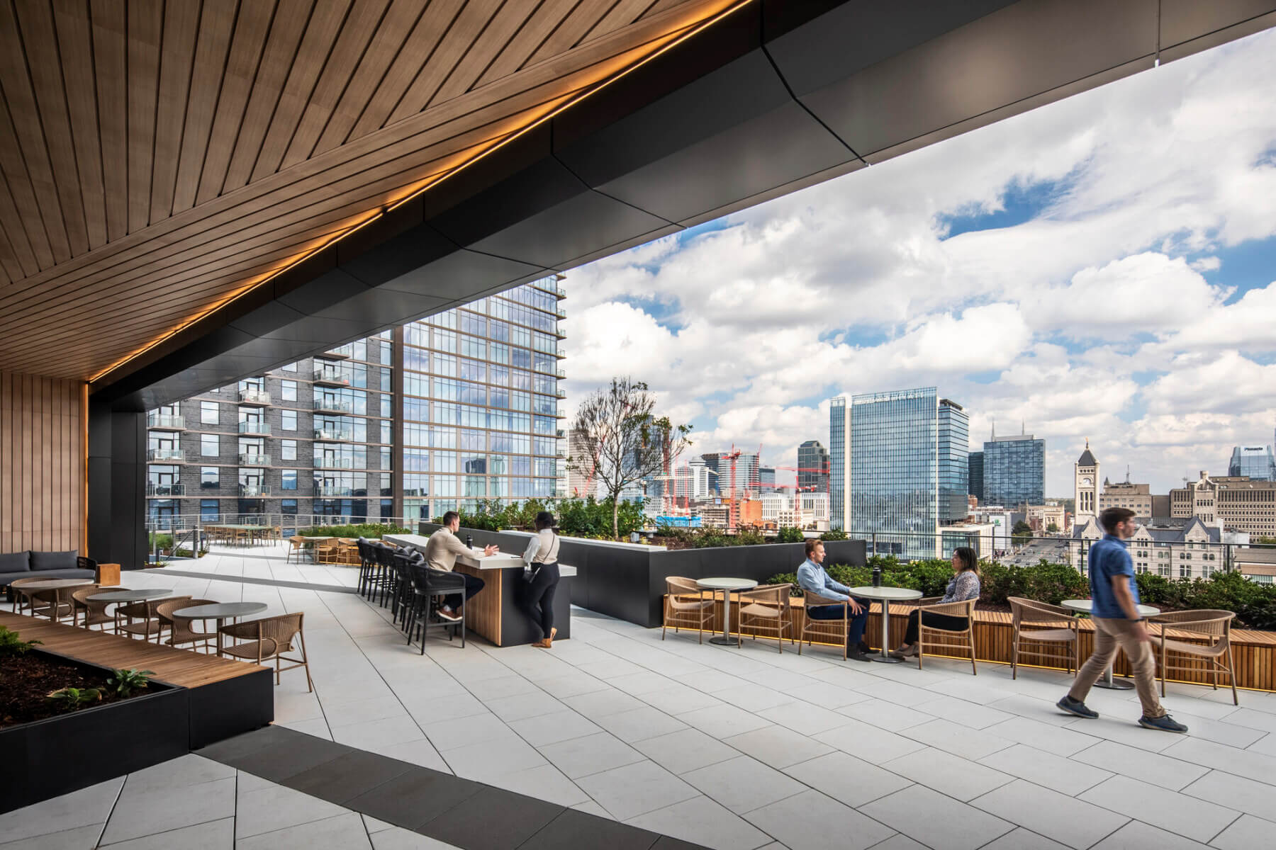 People interacting in an outdoor terrace space at ONE22ONE