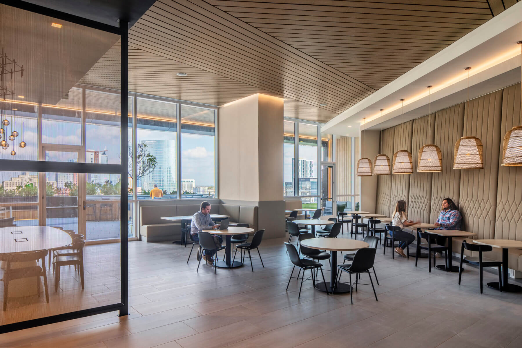 People interacting in a work café space at ONE22ONE
