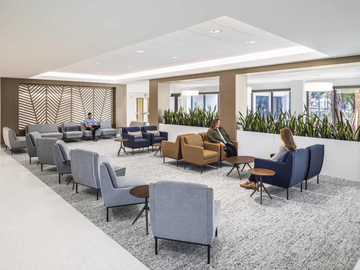 People sitting on couches and chairs in a hospital waiting area