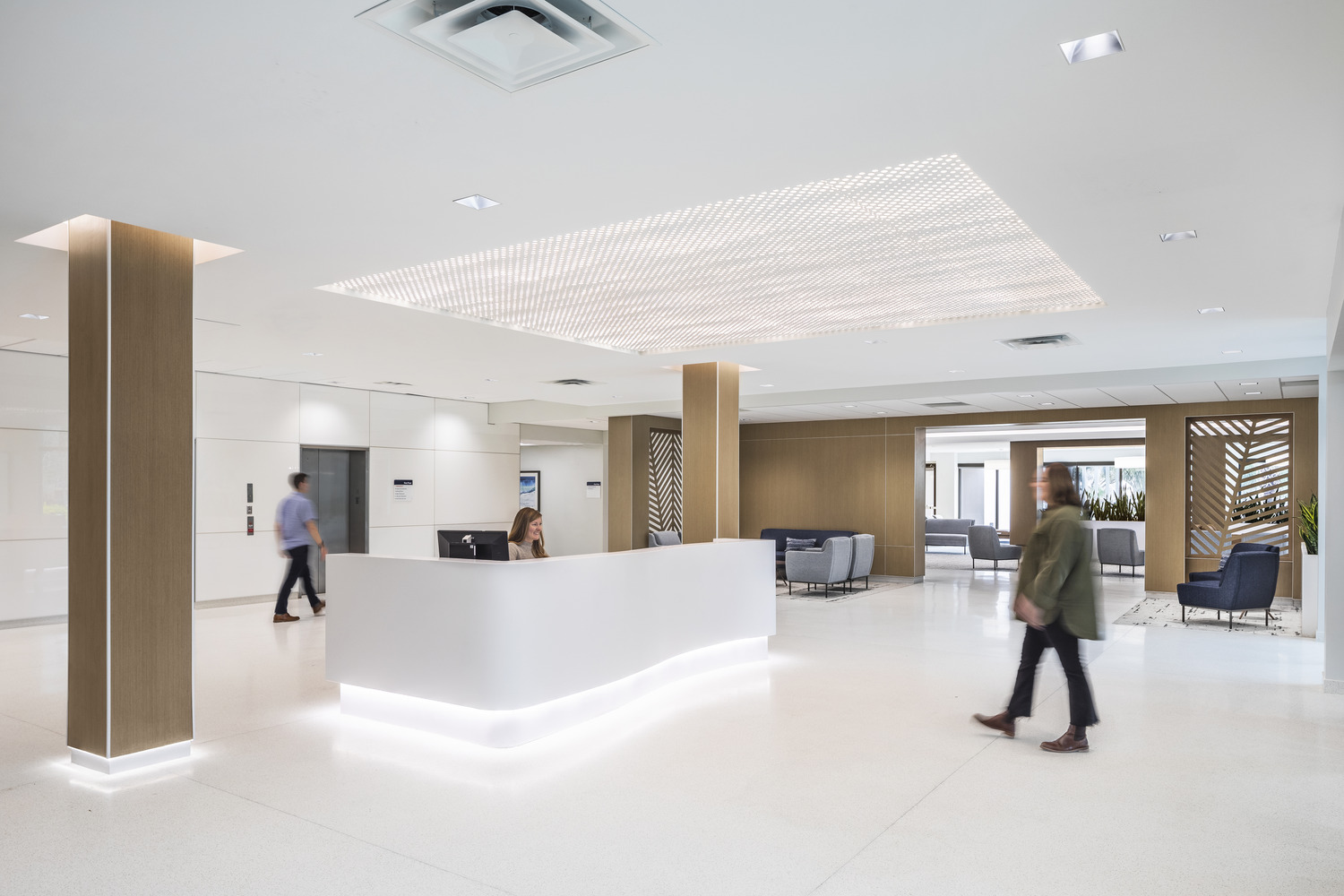 A person walking through a lobby towards a registration desk