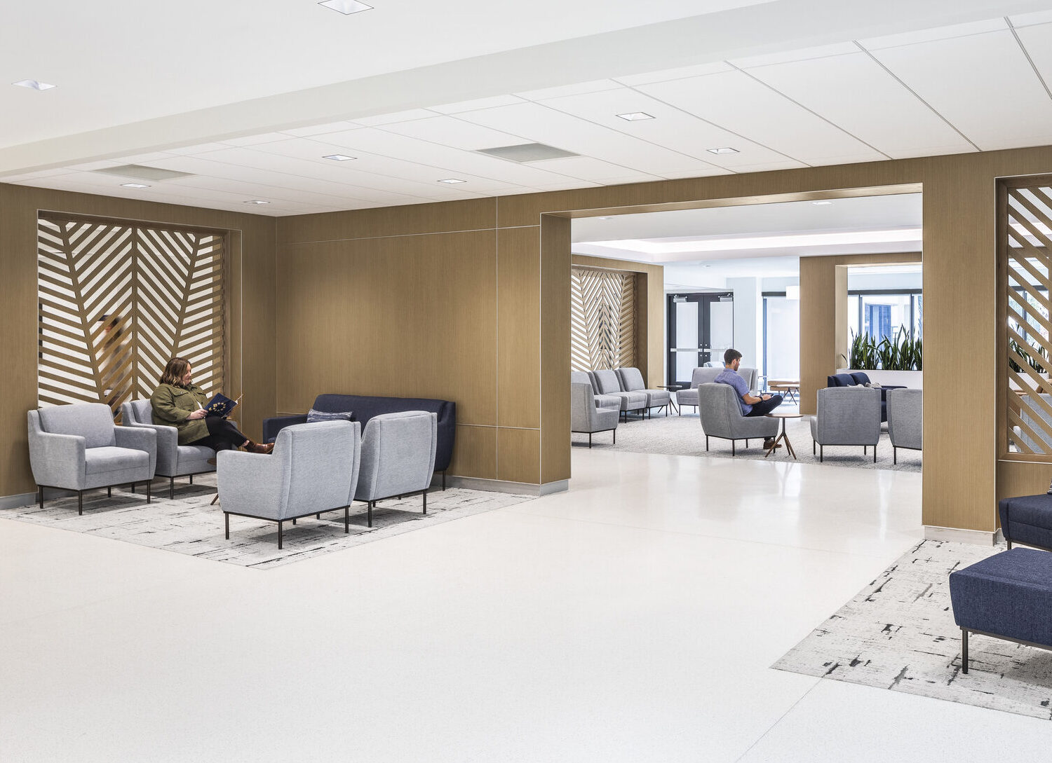 A person sitting in a chair in a secluded area of a hospital waiting room