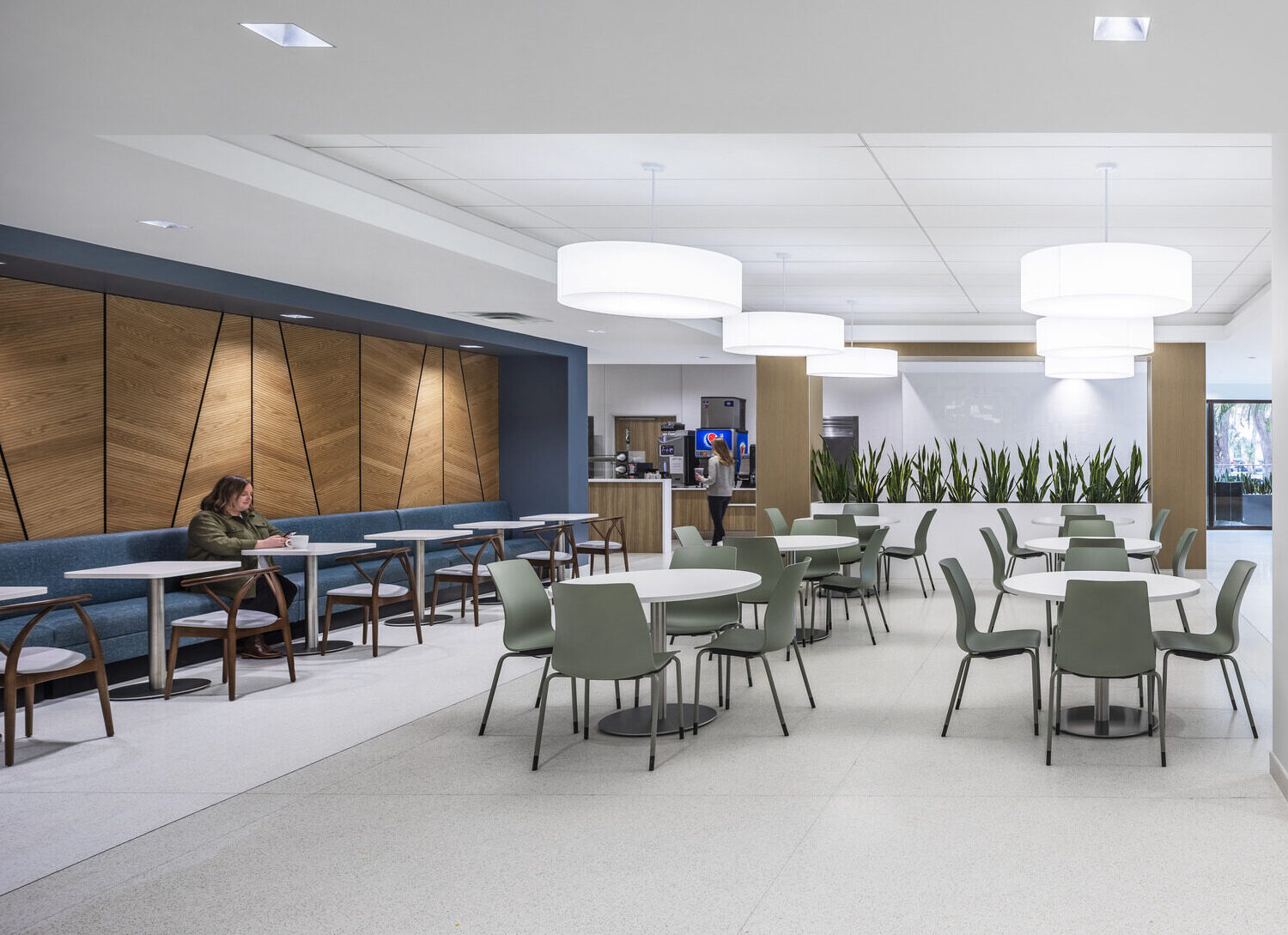 A person sitting at a table in a hospital cafe