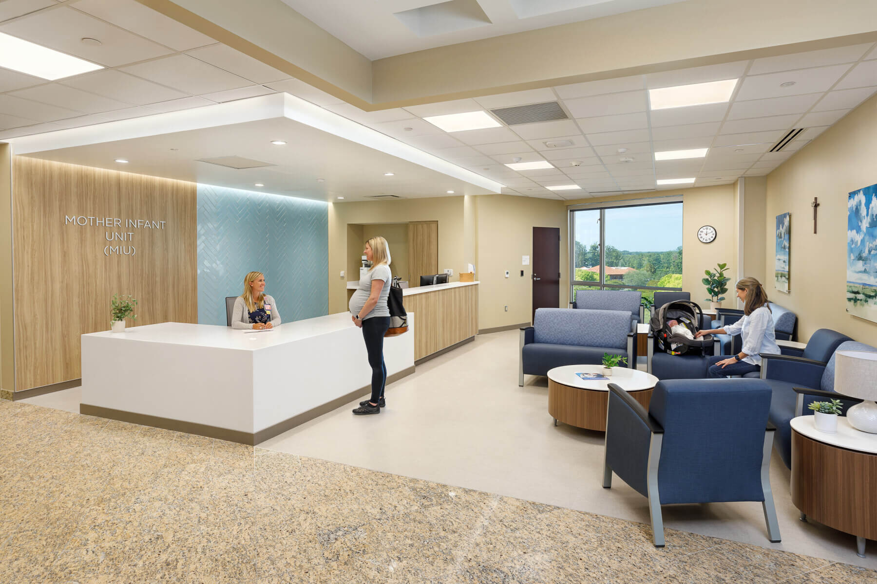 patients checking in at reception and seated in the waiting room