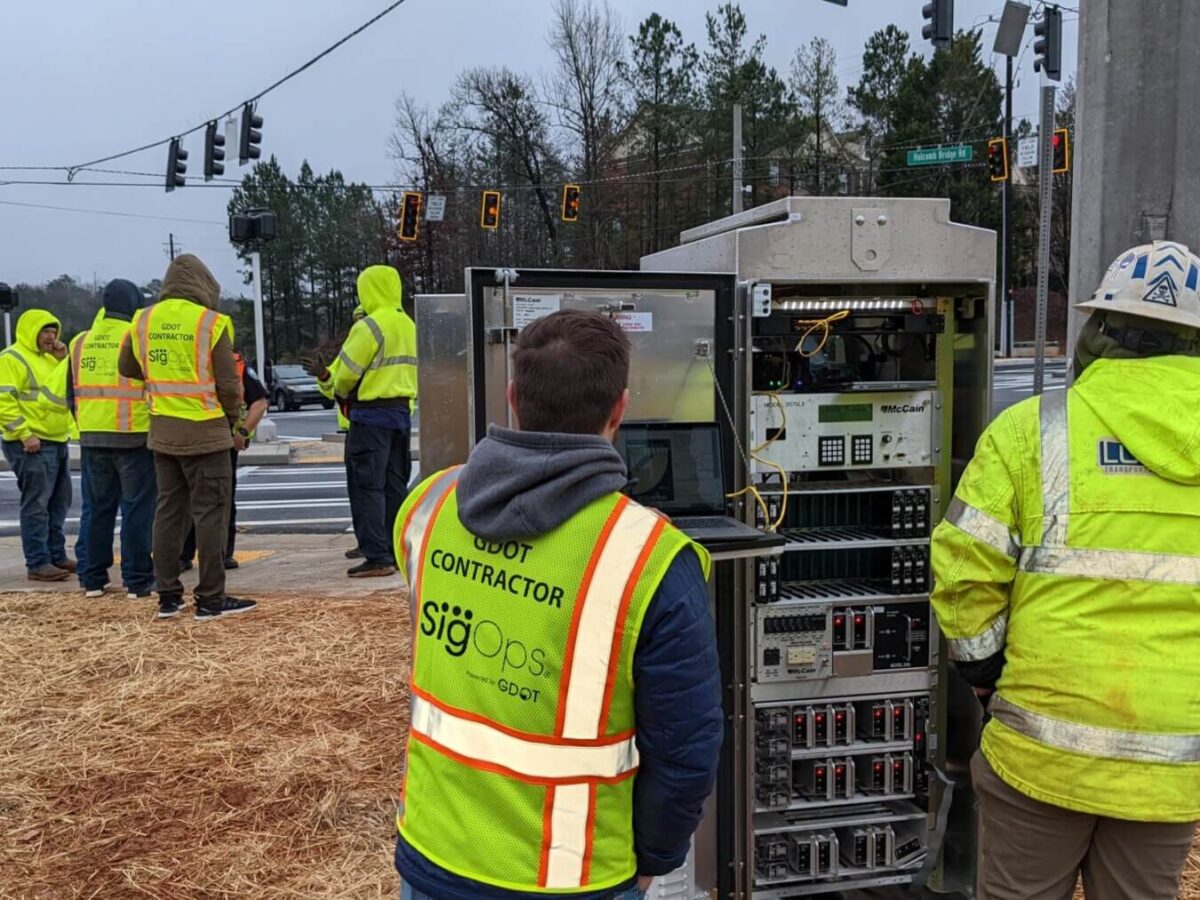 A group of people in yellow vests at a crosswalk for GDOT SigOps